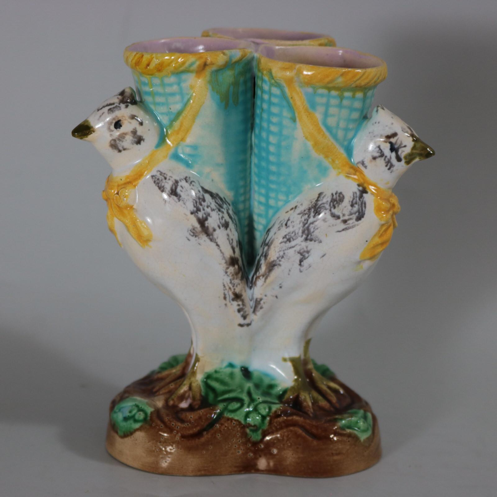 Unidentified English Majolica posy holder which features three birds, supporting baskets on their backs. Colouration: turquoise, white, green, are predominant. The piece bears maker's marks for the Unidentified English pottery. Bears a pattern