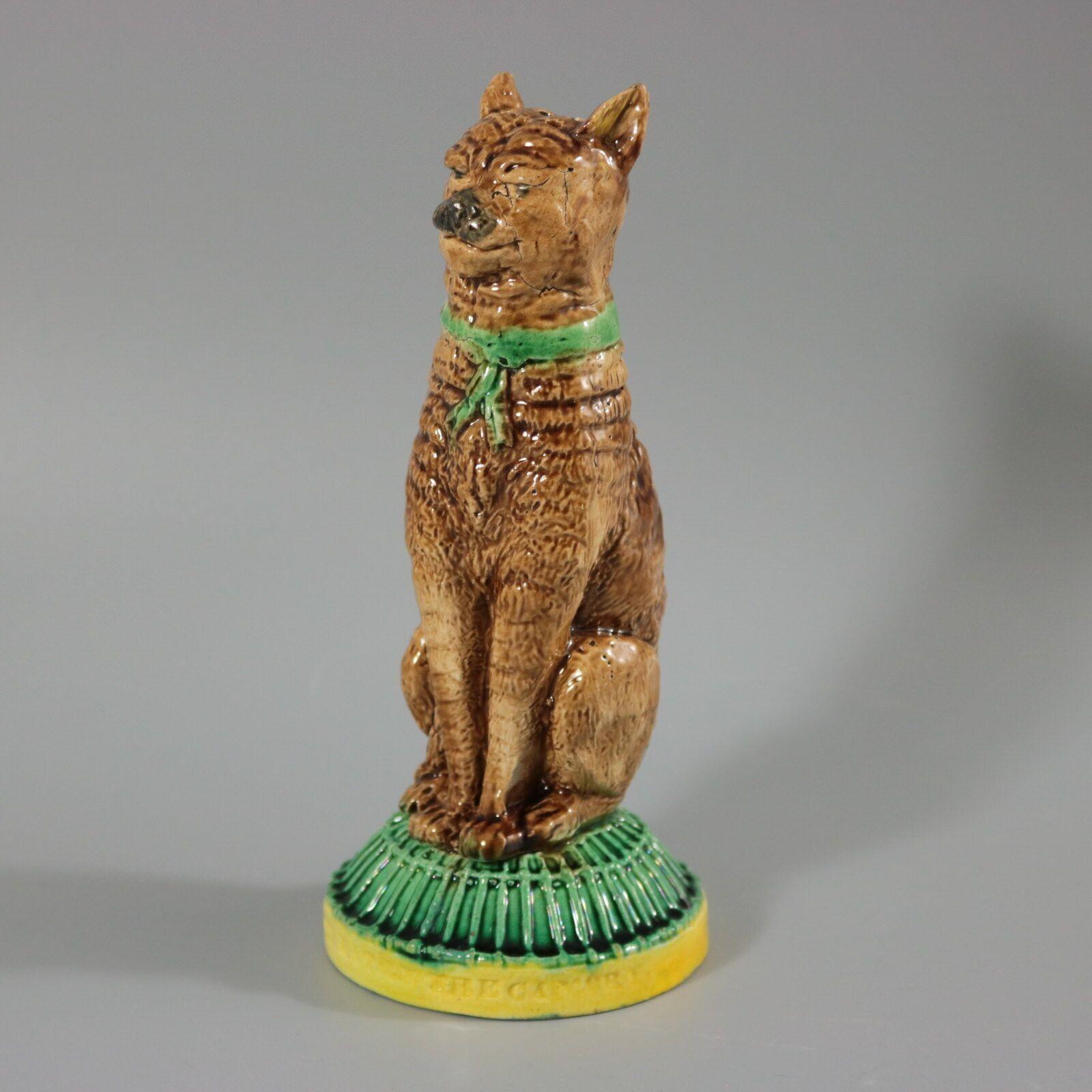 Unidentified English Majolica pepper/salt shaker which features a seated cat, with a self-satisfied expression on it's face. Base in the form of a cage, impressed, 'IVE EATEN THE CANARY'. Colouration: brown, green, yellow, are predominant.