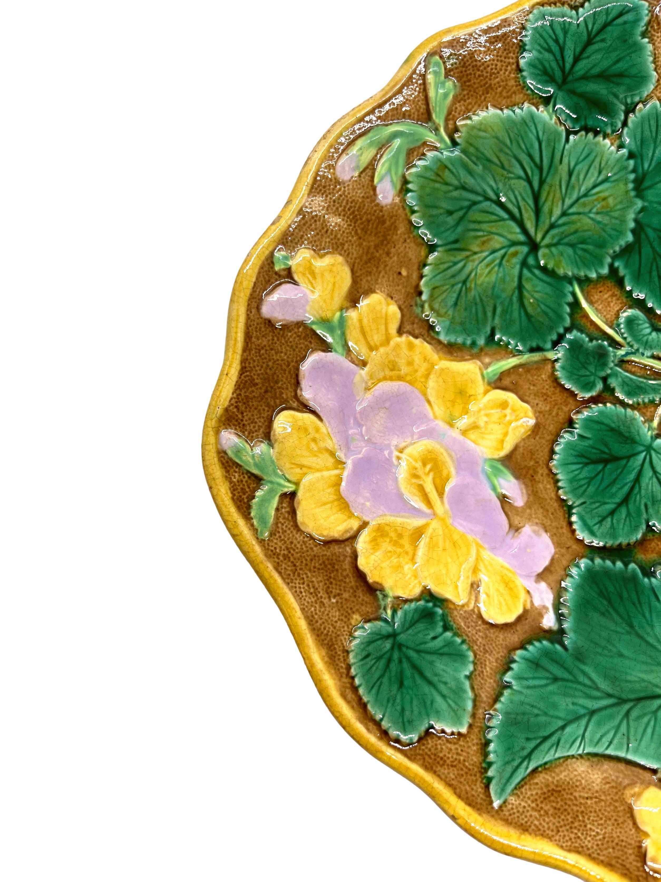 English Majolica dessert tray, the relief molded dish with geraniums and leaves, glazed in green, pink, and yellow on a rustic brown ground, ca. 1880.
For thirty years, we have been among the world's preeminent specialists in fine antique Majolica.