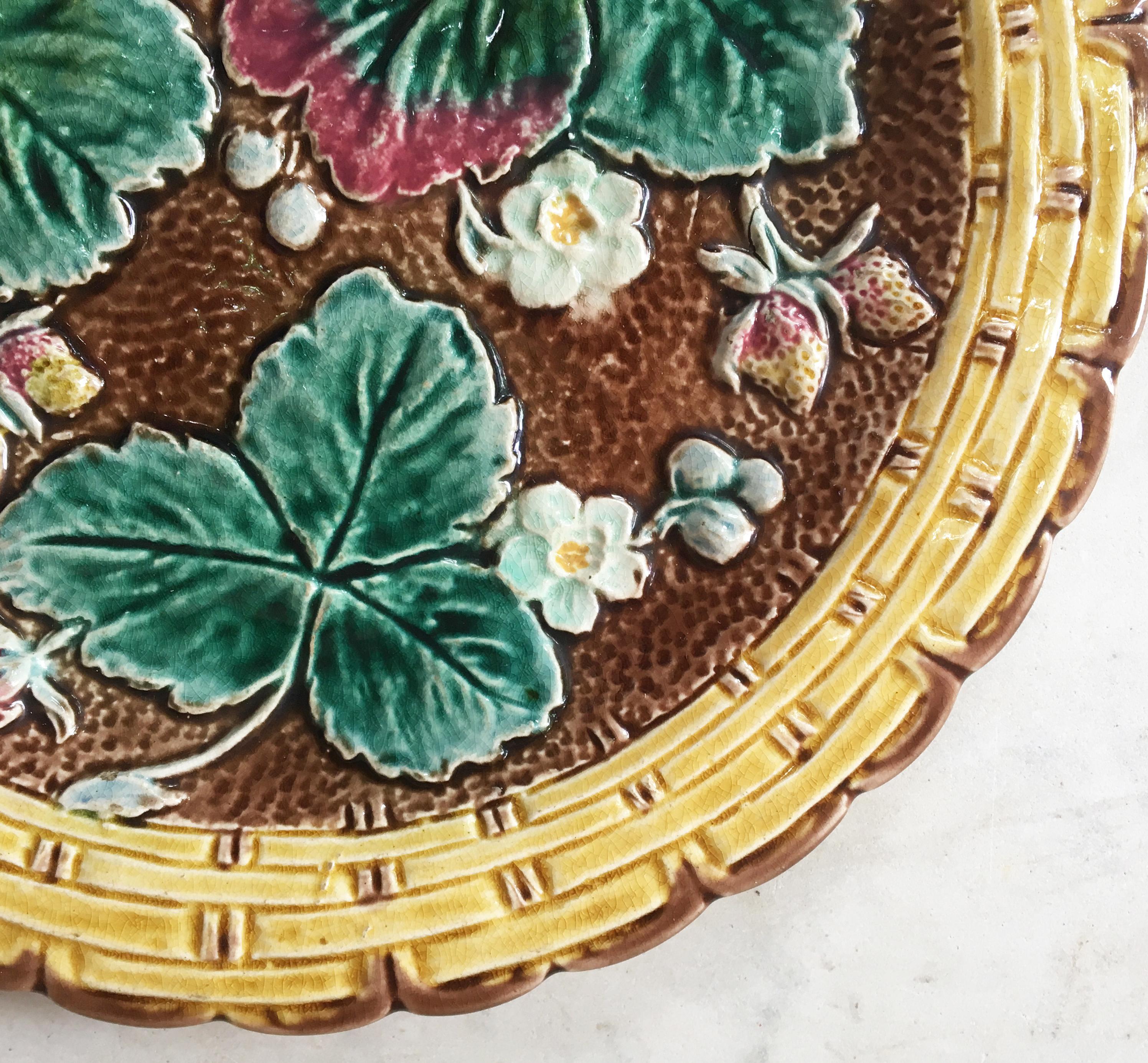 Victorian Majolica strawberries plate with a yellow basket weave border, circa 1880.
