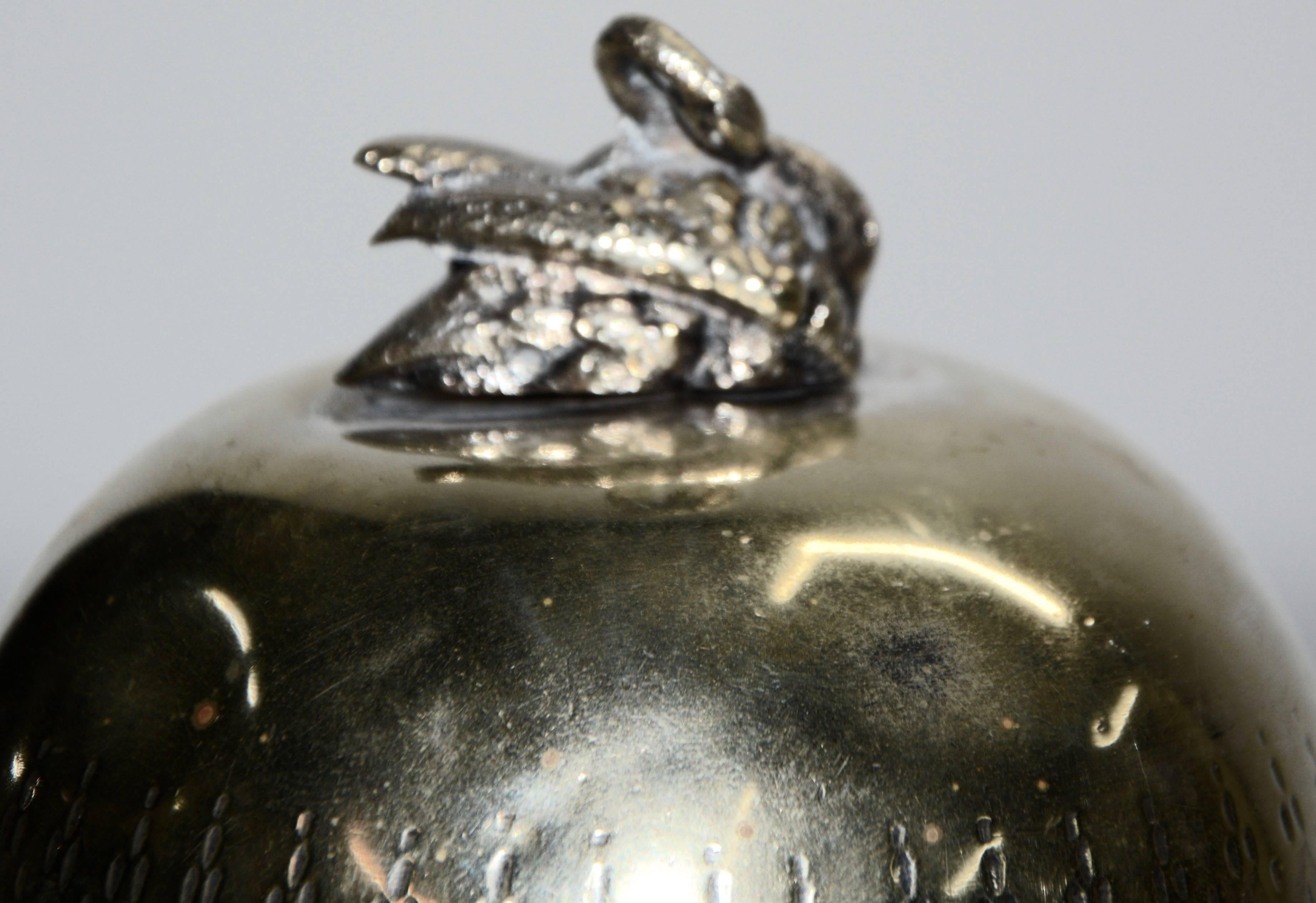 This is a unique piece by Mappin & Webb of Sheffield. It features an elegant swan at the top and the body of the warmer has delicate engraving. This sits atop scrolled legs with a plate to hold the spirits burner. Inside there is a removable ring