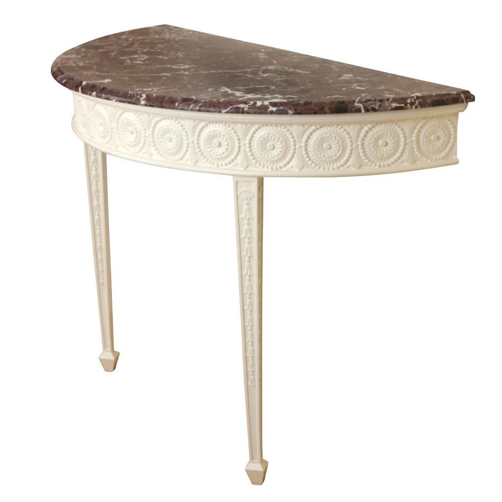 English marble tops a Georgian style white painted demilune console table.