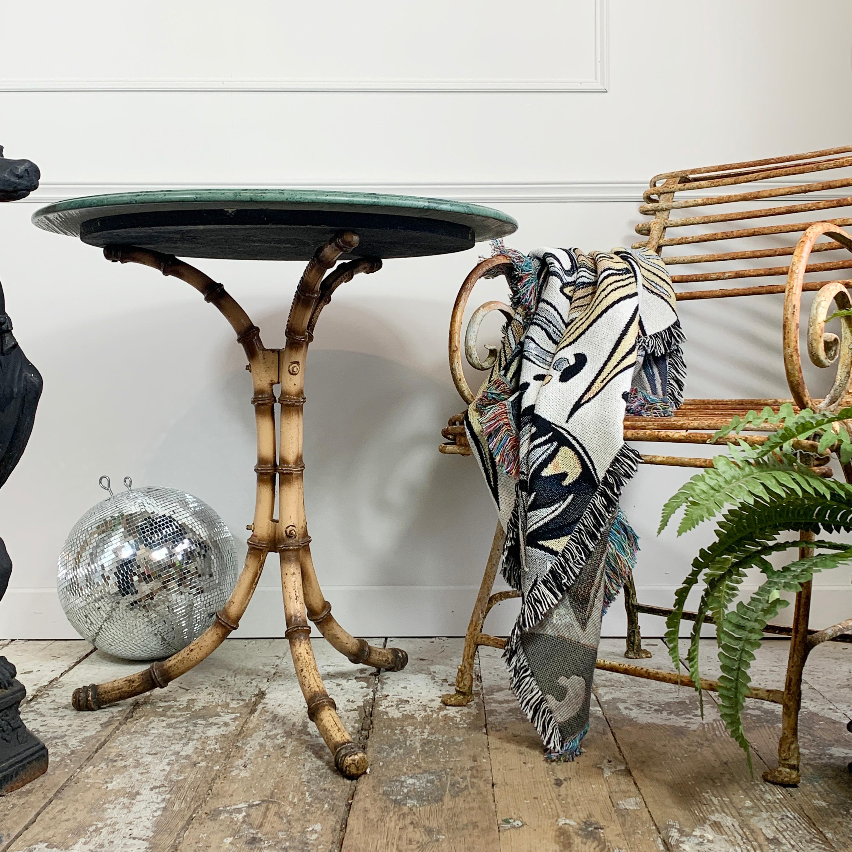 An absolutely beautiful cast iron faux bamboo café table, painted to replicate the look of matured bamboo, this table was made in England in the early 1900’s, is fully stamped to the leg, and has a stunning green marble top. 

The marble top is