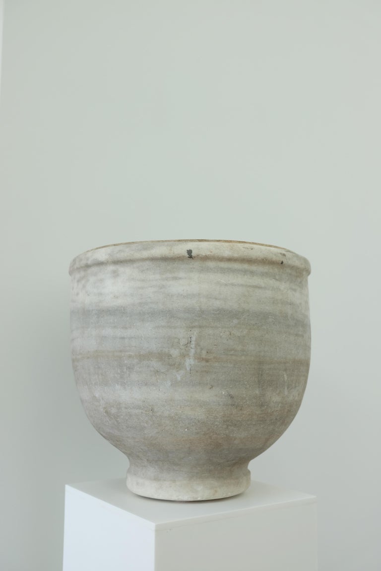 English marble vase. Deep ovoid form rising to a shaped and molded bullnose edge with flat rim, tapering to a flaring foot, 1850s. Classical form with a beautiful patina.
