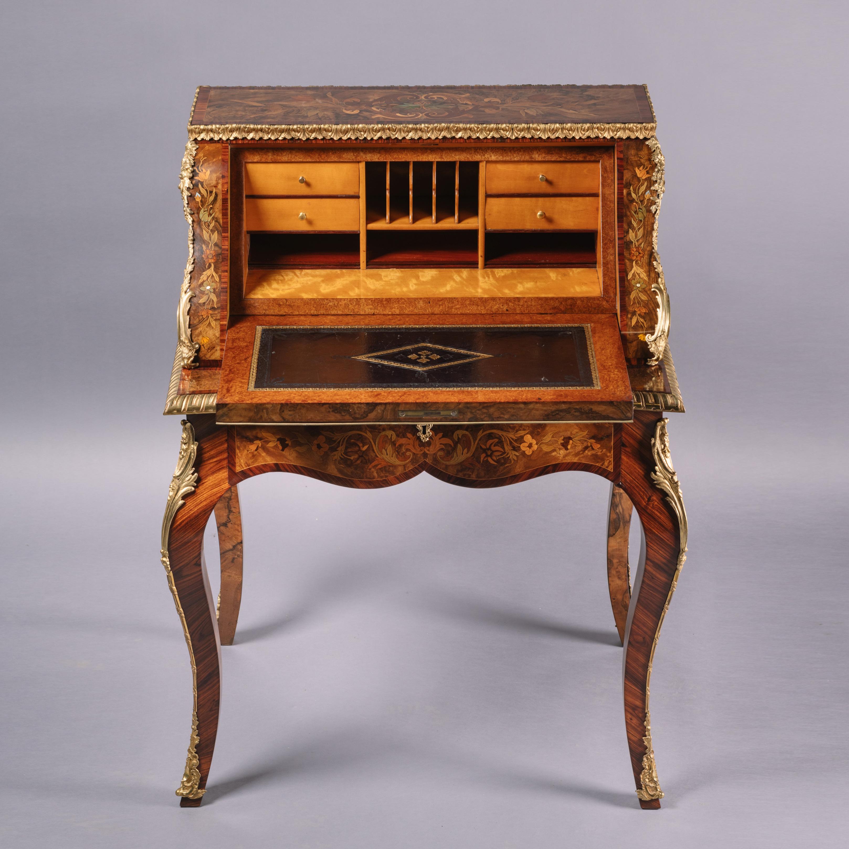 A fine Victorian gilt-bronze mounted marquetry inlaid Bureau De Dame.

This richly decorated bureau de dame is of bombe shape beautifully inlaid overall with marquetry foliate sprays, exotic birds, butterflies, shells, and foliage.

The