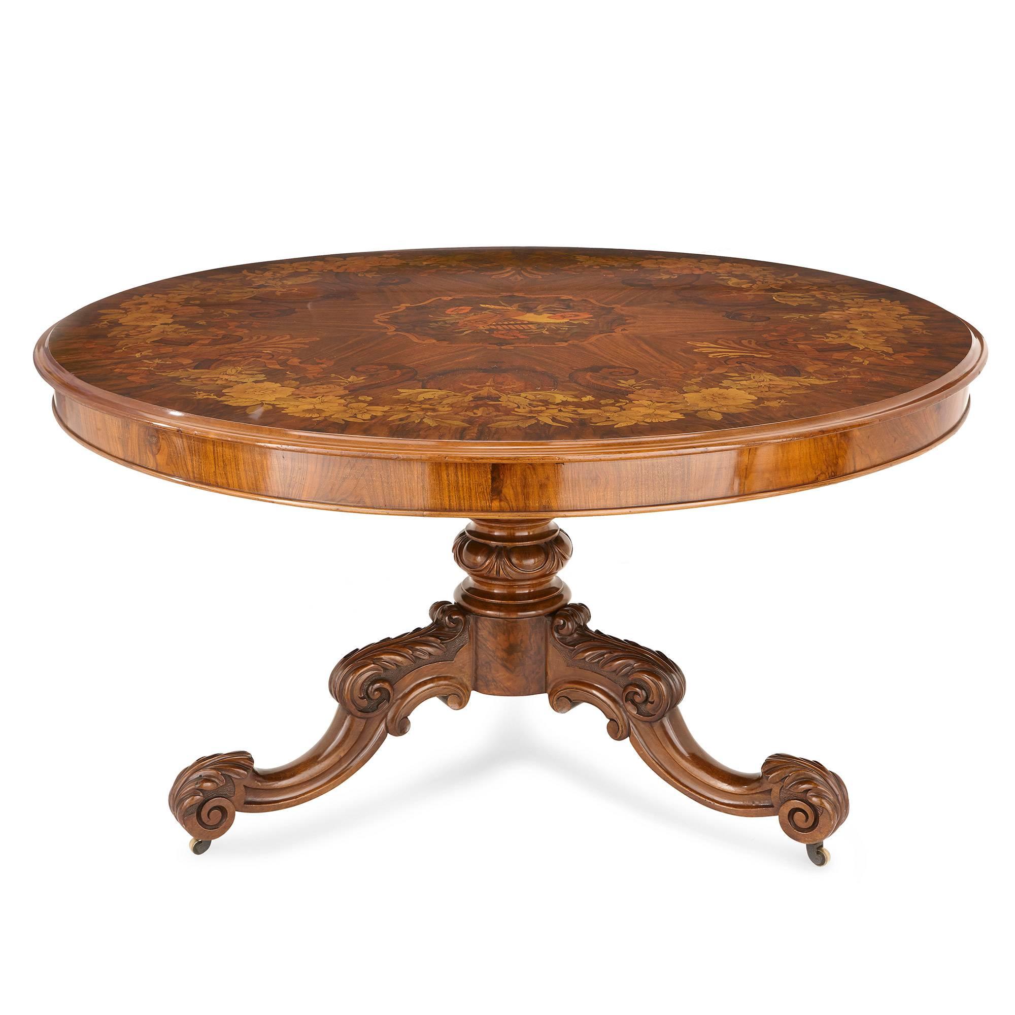 This centre table is well suited to a range of interior settings, and will add Victorian sophistication and charm to any room. Its top can be tilted from flat to upright, so as to better display the Fine marquetry decorations which adorn the front