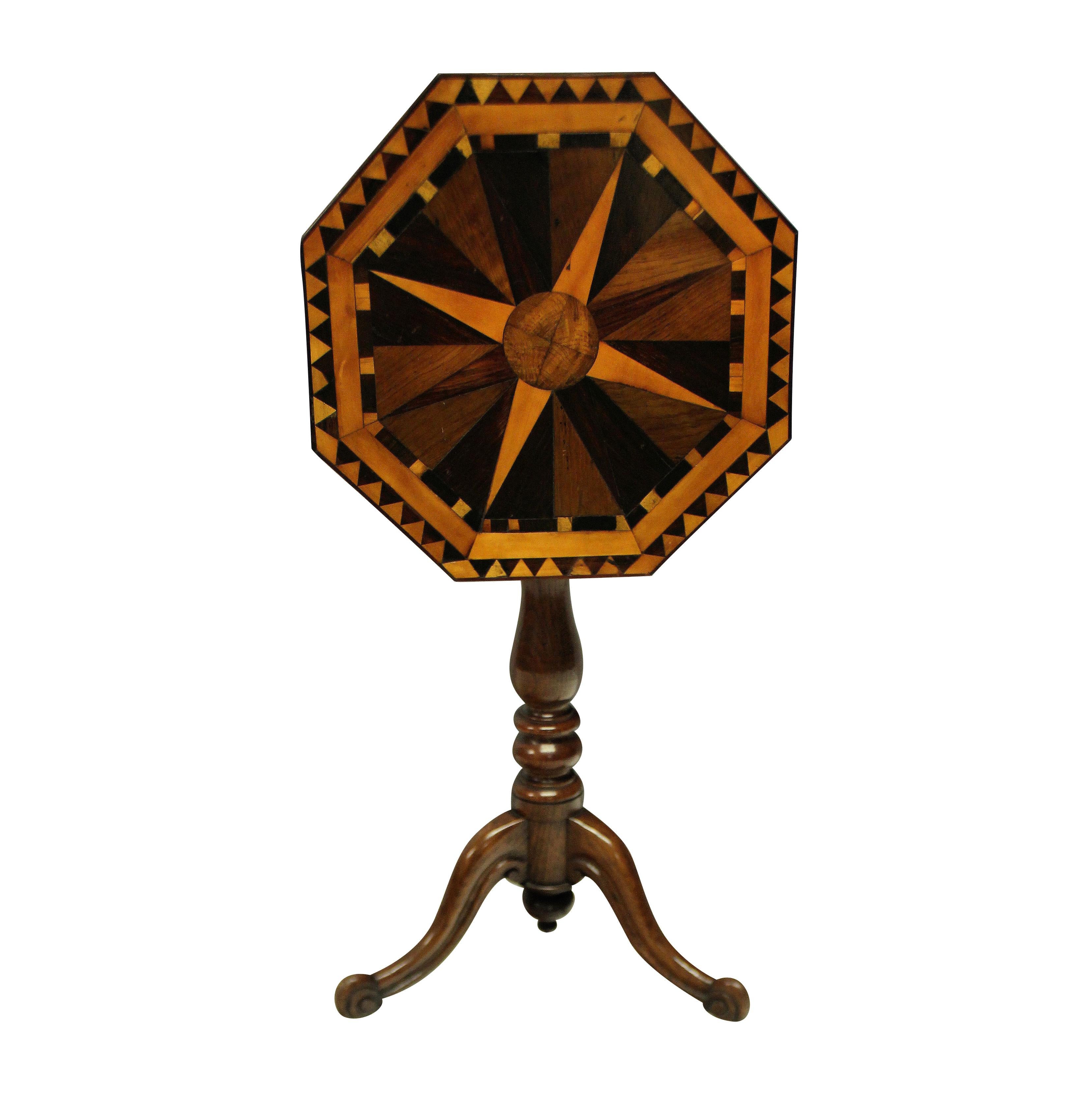 An English pedestal tilt top side table in oak and elm with a fine geometric marquetry top in various English woods depicting a globe and compass. The turned tripod base supporting a tilt top with scalloped apron with original latch.