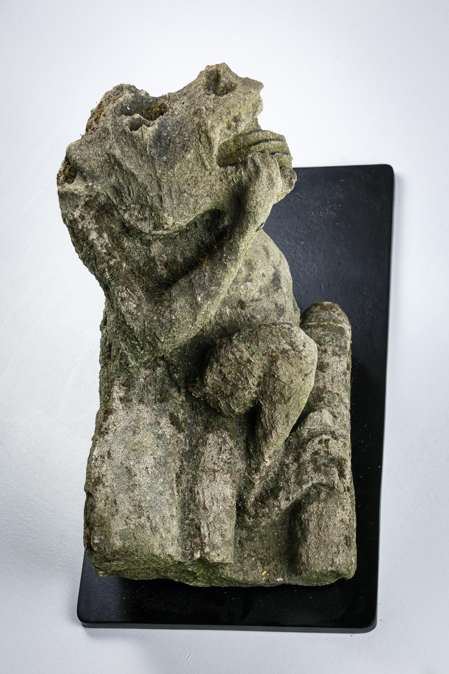 Carved Stone Gargoyle 15th century, West Country, England. 
Considered as the protector of Churches by scaring away demons and evil spirits, predominantly adorning the exterior their oft open mouths symbolic of devouring giants. The were also