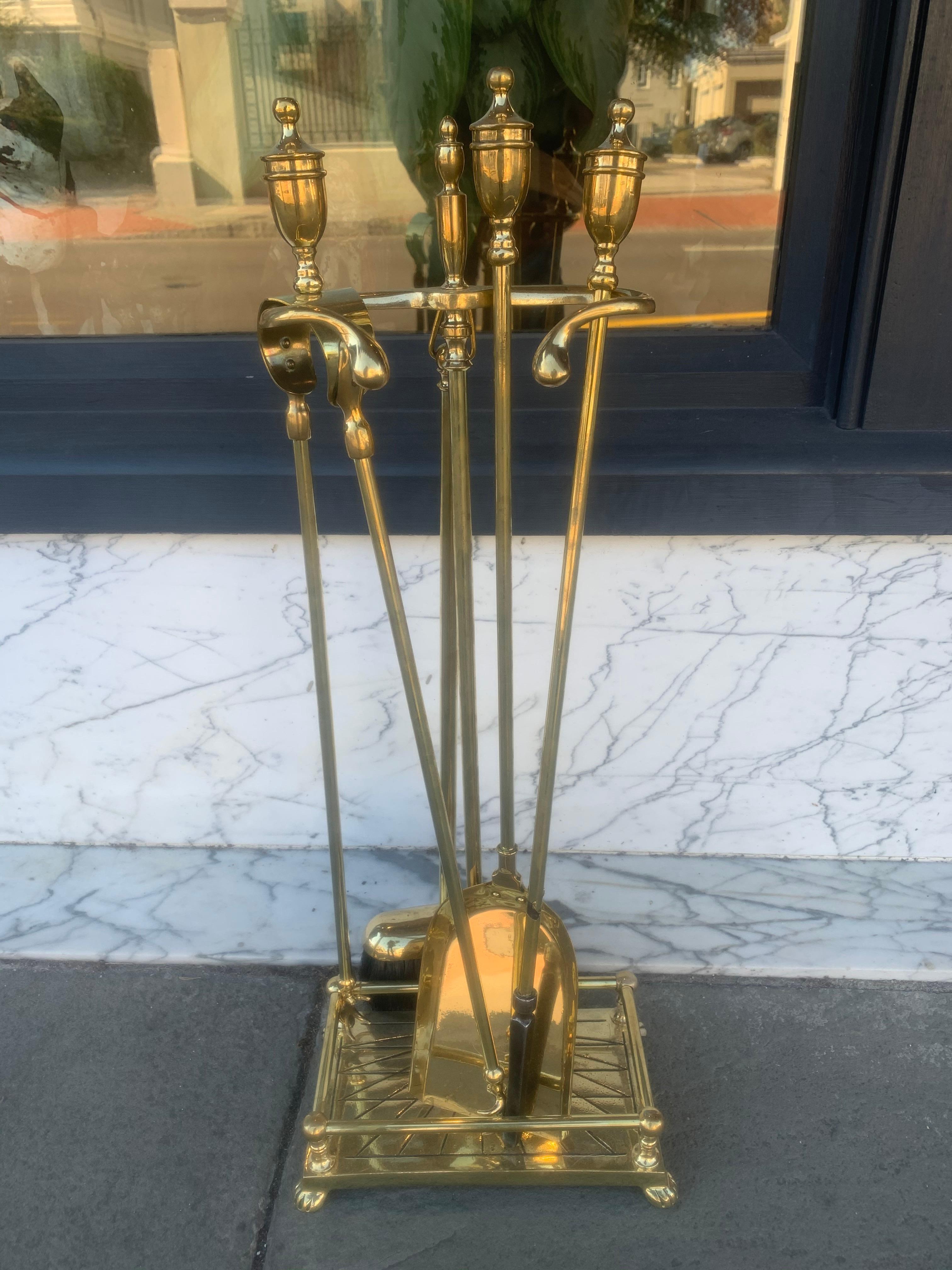 English mid-19th century brass fire tools with stand.