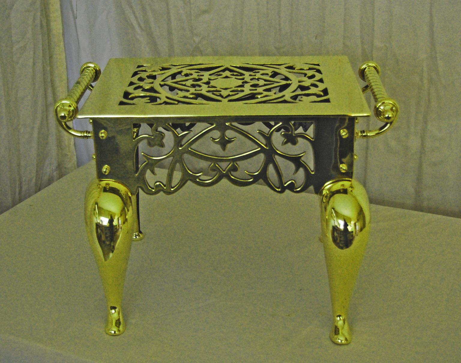   English cast brass footman with cabriole legs and pierced skirting on all four sides, twist side handles.   It is unusual to have the pierced skirting on the back as well as the other three sides.   This quite heavy fine quality footman was