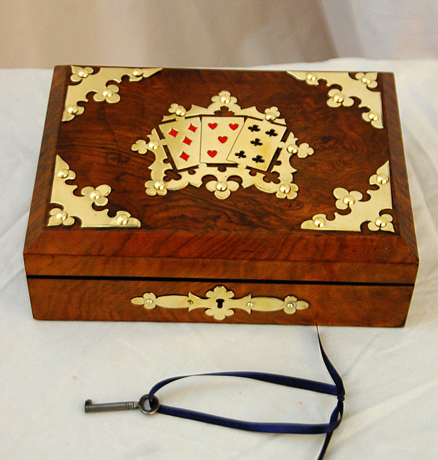 English mid-19th century burl walnut card box with brass overlay. This box is in exceptionally good condition with all of the brass beautifully polished and the burl walnut glowing. The interior has four compartments for cards and counters; the