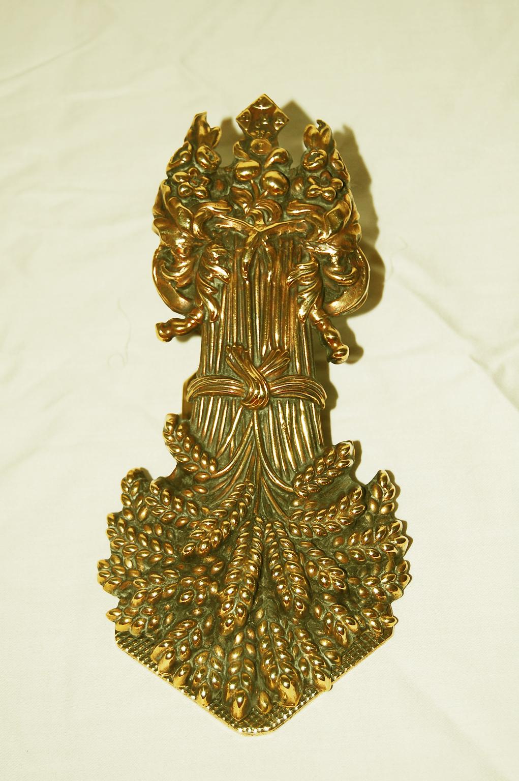 English signed and dated brass paper clip of unusual form. This large paperclip is spring loaded and will hold many notes securely. It was designed to sit either on a flat surface, such as a desk, or hang from the wall, as today possibly in a