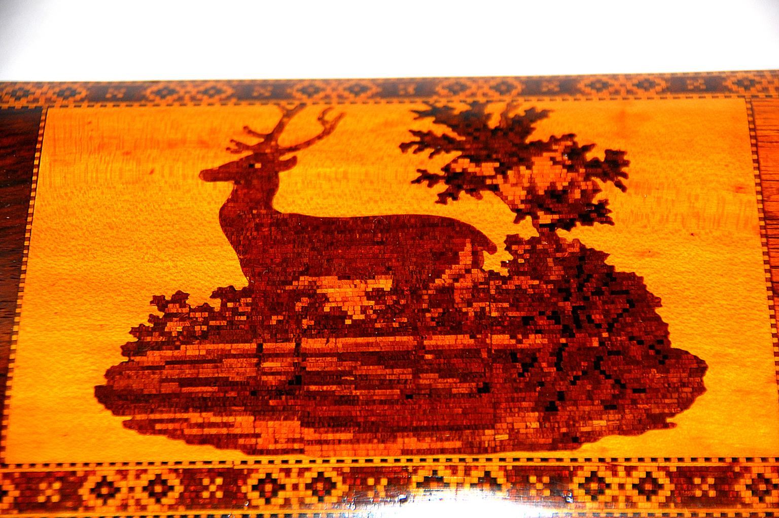 English mid 19th century rosewood tunbridge inlaid teacaddy with deer and fawn motif to the top. This micro tunbridge inlaid box is in superb condition, it's subtlety waisted shape and multiple borders set off the central boxwood cartouche of the