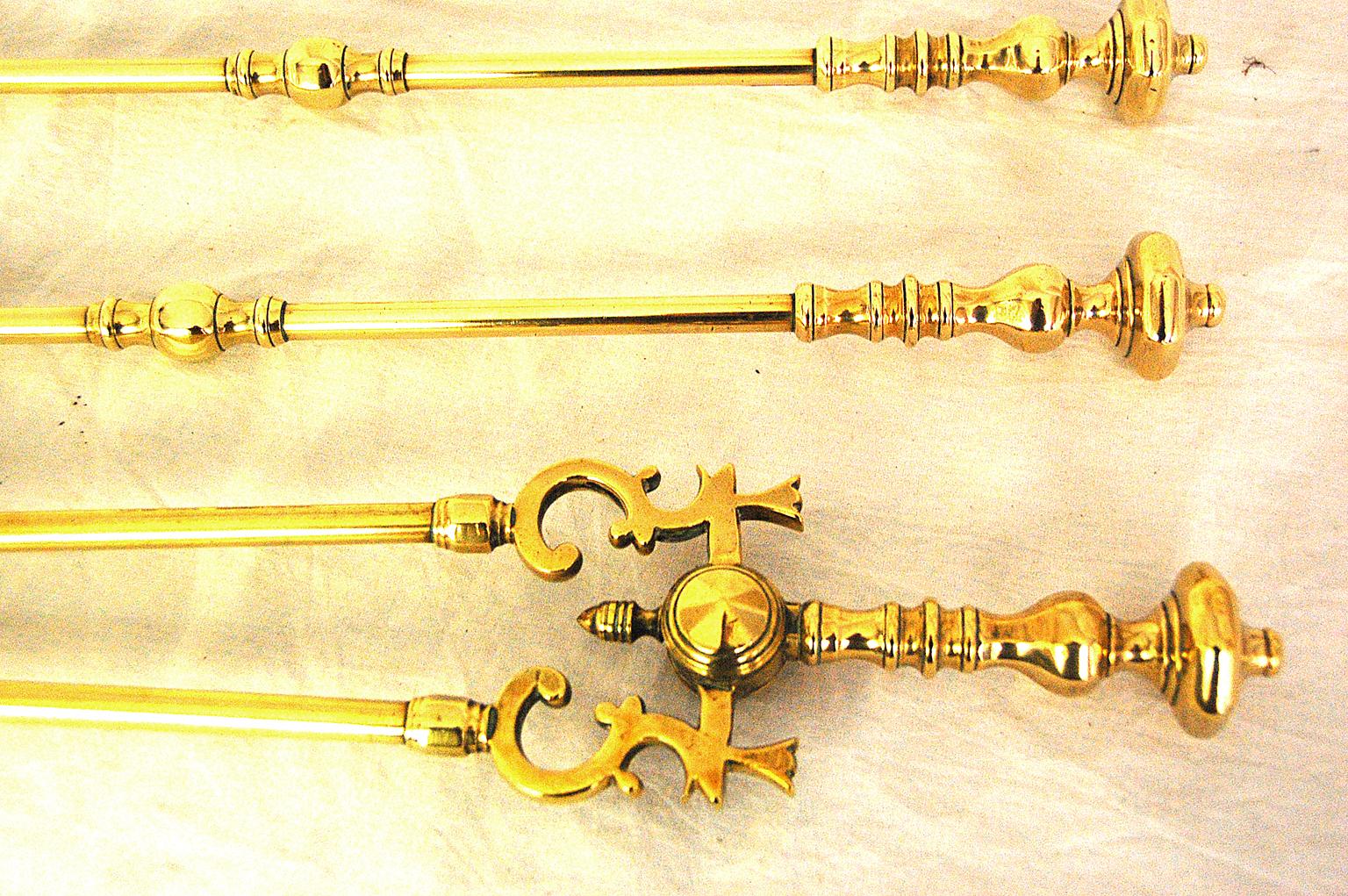English set of three cast brass firetools of the mid-19th century period, very heavy quality, in good working order, including a pierced shovel, fire tongs, and poker. The octagonal knopped handles are an unusual design, circa 1850.
