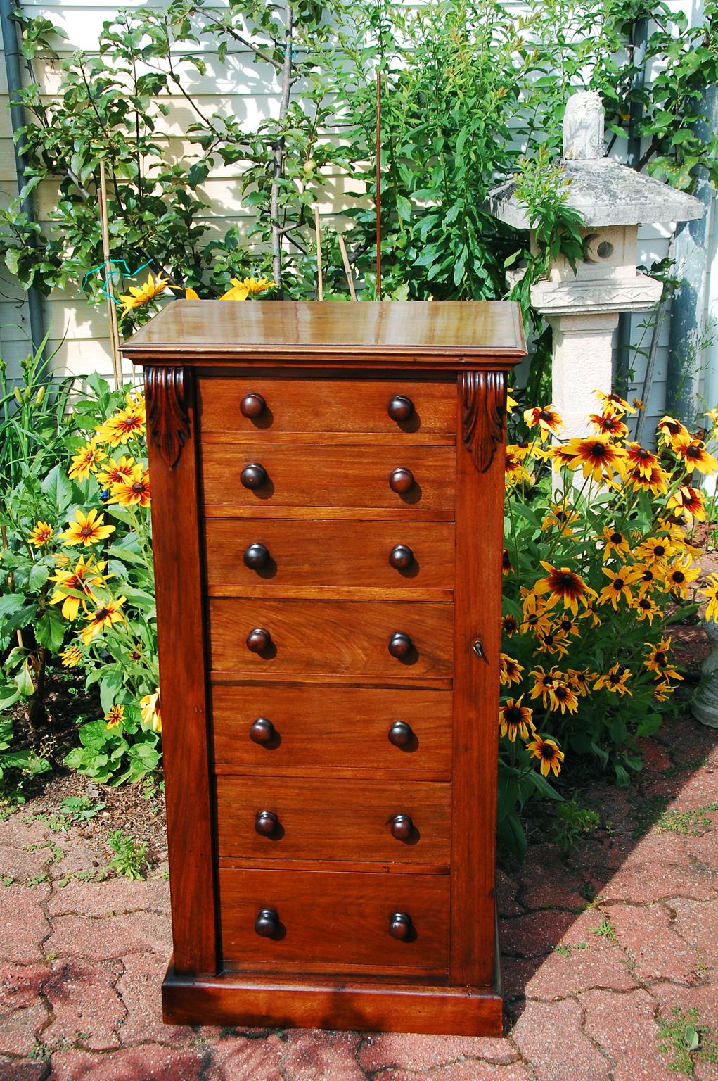 English mid 19th century walnut Wellington chest of seven graduated drawers. The Wellington chests are distinguished by having a locking bar on the front, usually right hand side, that hinges outward. When it is closed, it overlaps the edges of all