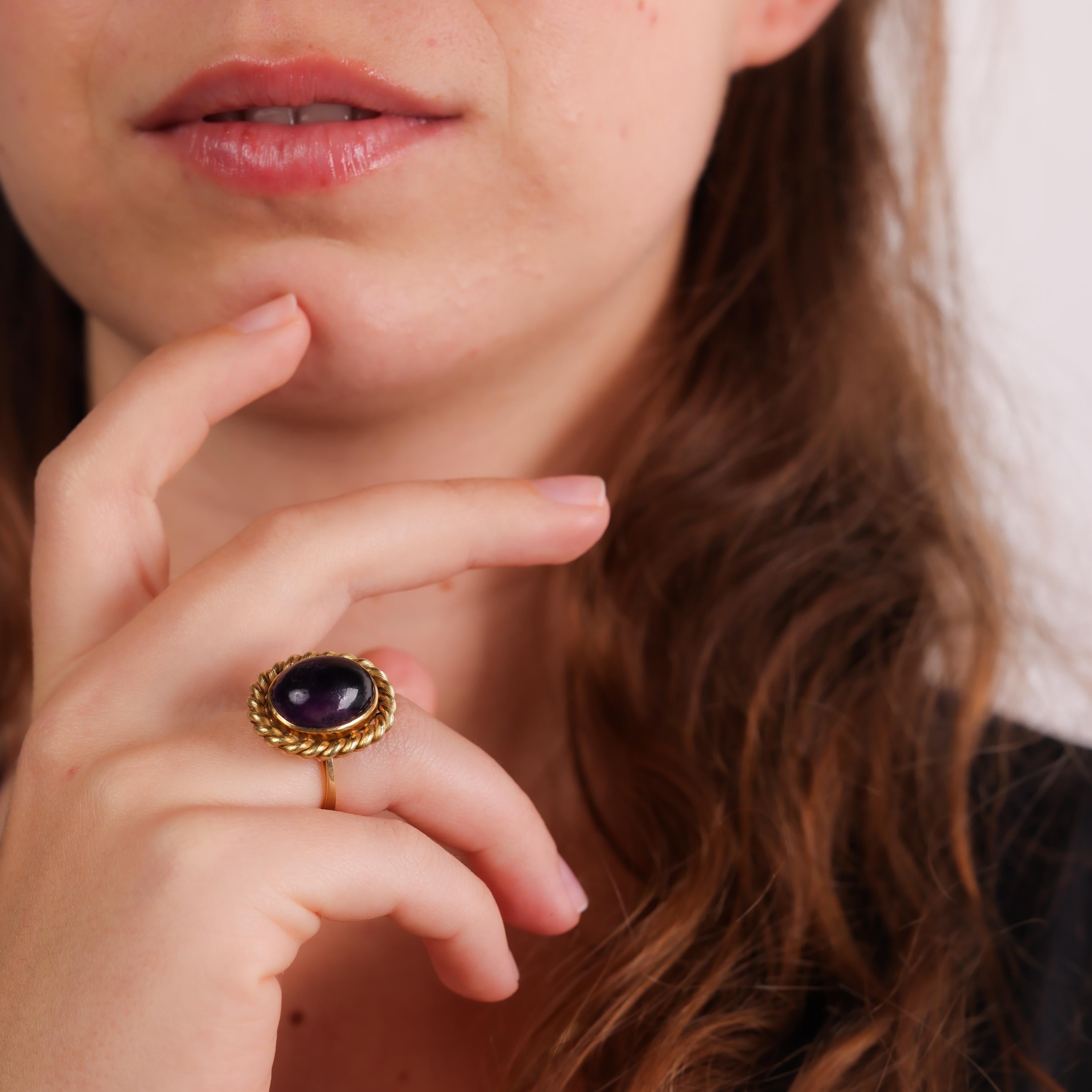 This Mid Century 18k yellow gold ring showcases a striking cabochon-cut amethyst, offering a bold yet timeless design with elegant craftsmanship from the 1960s.

Center stone: Cabochon cut amethyst 
Metal: 18k yellow gold
Era: Mid Century
Circa: