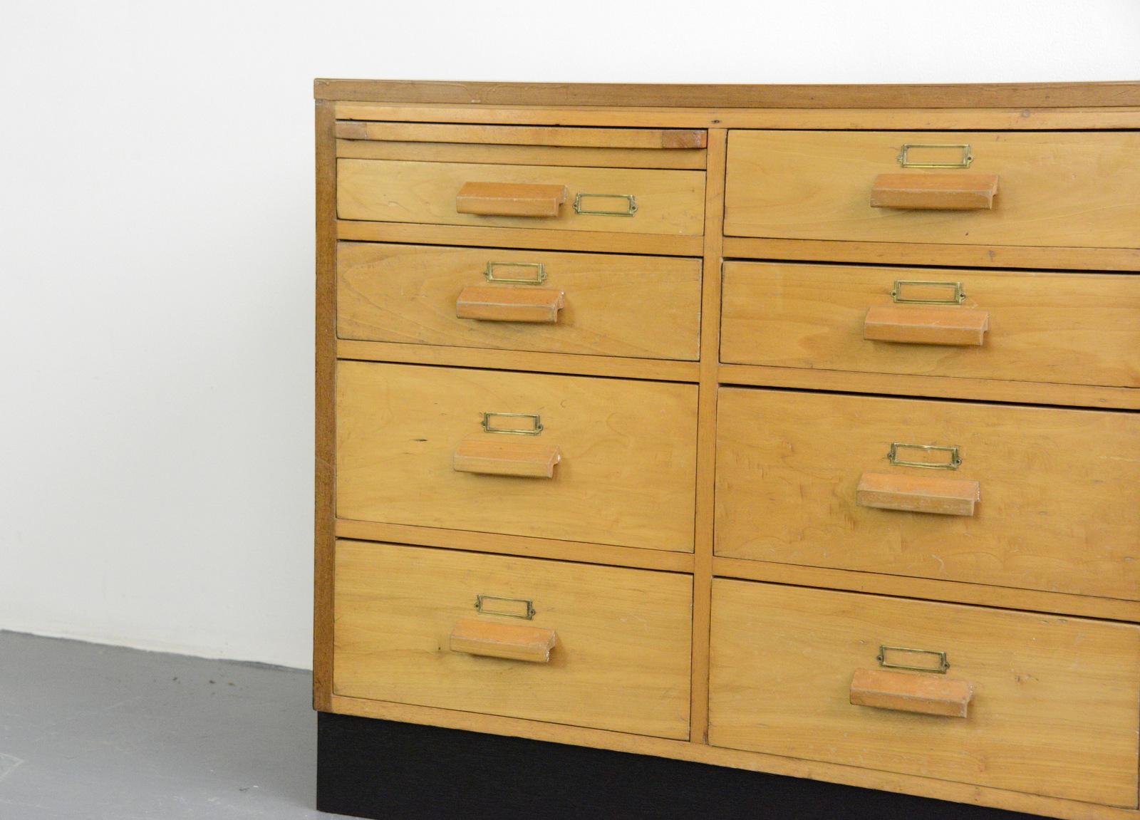 English midcentury beech post office drawers

- Solid beech with teak top
- Original brass card holders
- Black ply back and sides
- Originally came from a post office
- English, 1950s
- Measures: 183 cm long x 47 cm deep x 83 cm