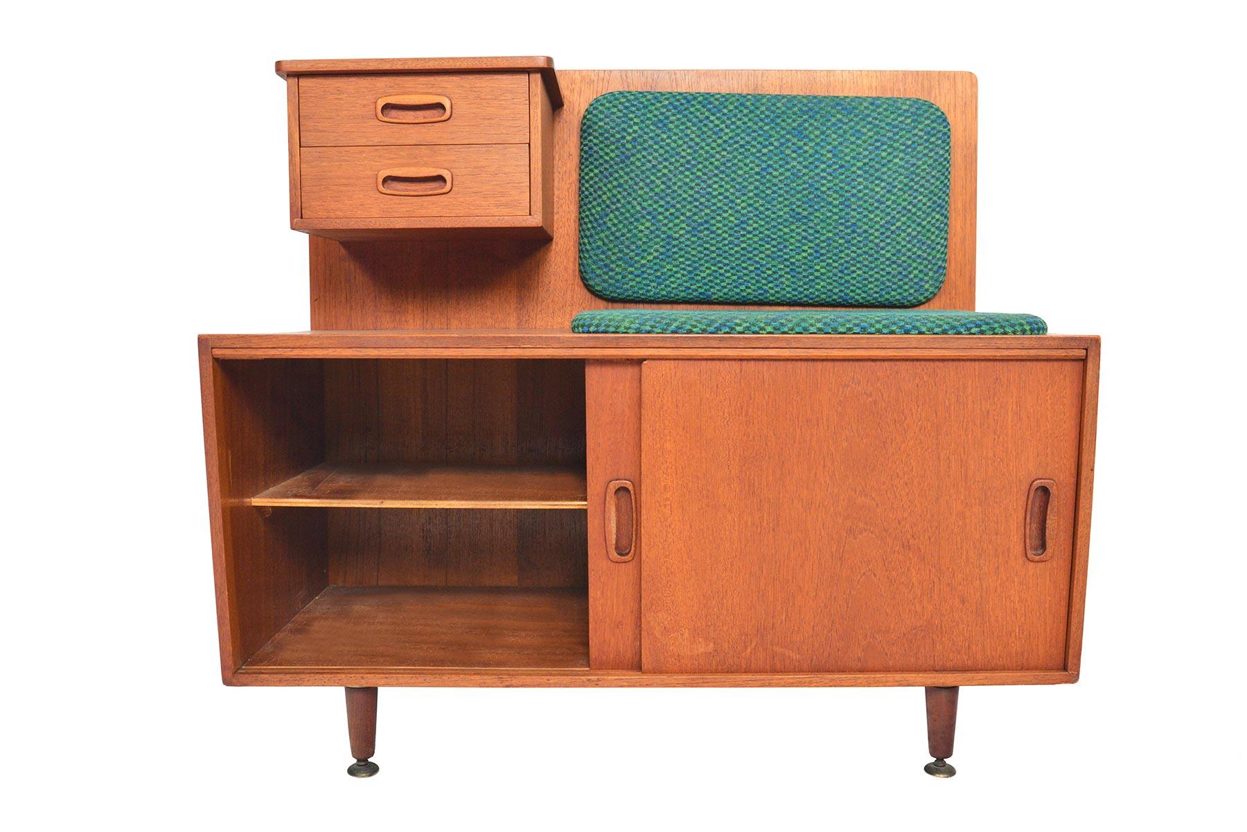 This English Mid-Century Modern telephone bench by Jentique is crafted in teak to provide a compact design for seating and storage. Perfect for any entryway, this time capsule design offers two fabric covered cushions. A wonderful storage piece,