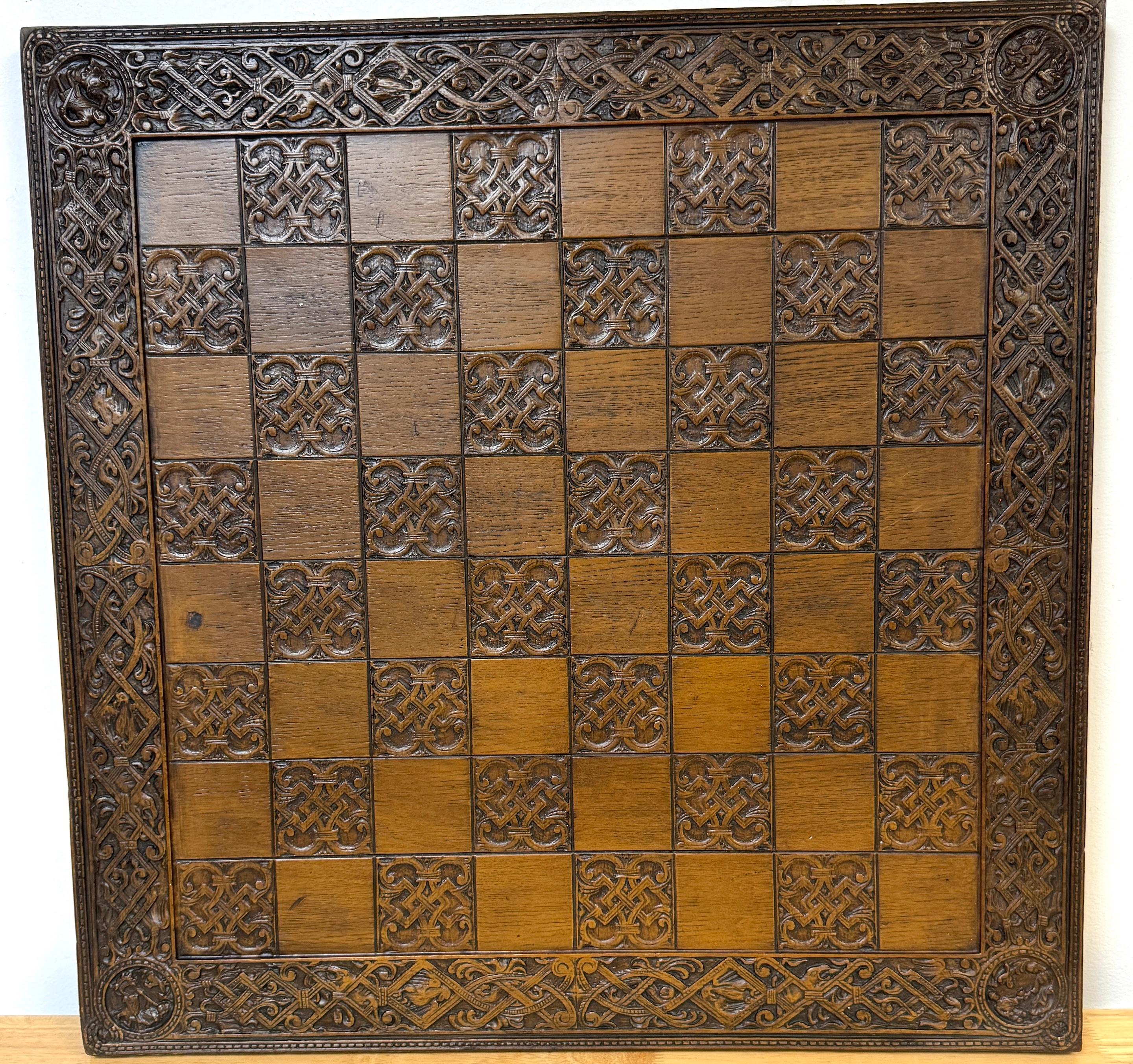 English Mid Century Large Syroco Wood Celtic/GGothic Motif Chess Board 
England, 1970s

This English Mid-Century chess board, dating from the 1970s, is a large and visually striking piece, measuring 23.5 inches square by 1.25 inches high. Made of
