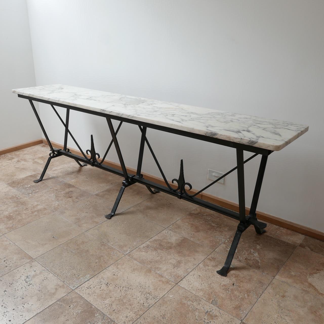 A well designed console or garden table ideal for indoor or outdoor use.
Hand beaten metal base with a marble top.
English, circa 1980s.
Some wear to the marble, some scratches and knocks to be expected but no cracks and generally good