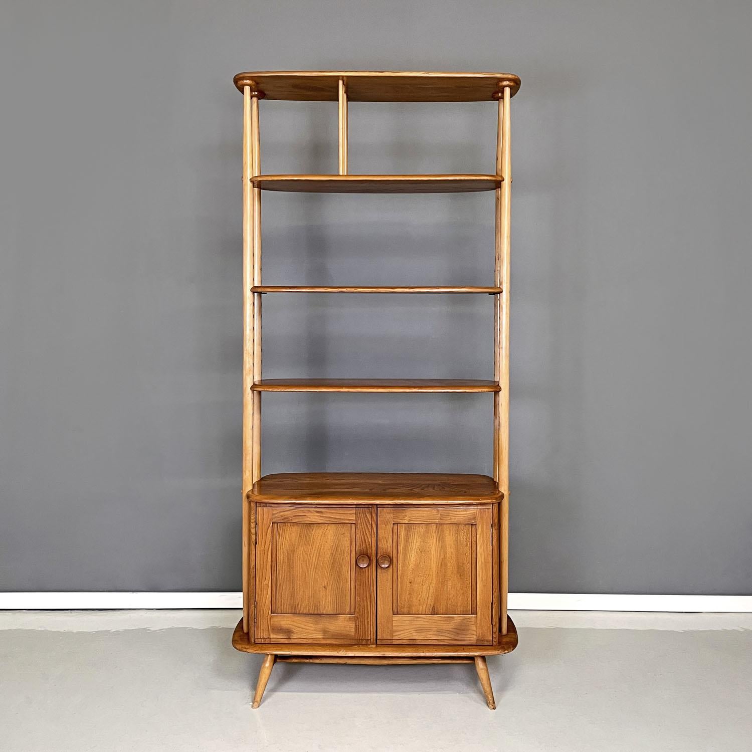 English mid-century modern light wood library with cabinet by Ercol, 1960s
Wooden bookcase with a rectangular base with rounded corners. It has three shelves, the one on the side is connected to the upper floor via four round-section wooden slats