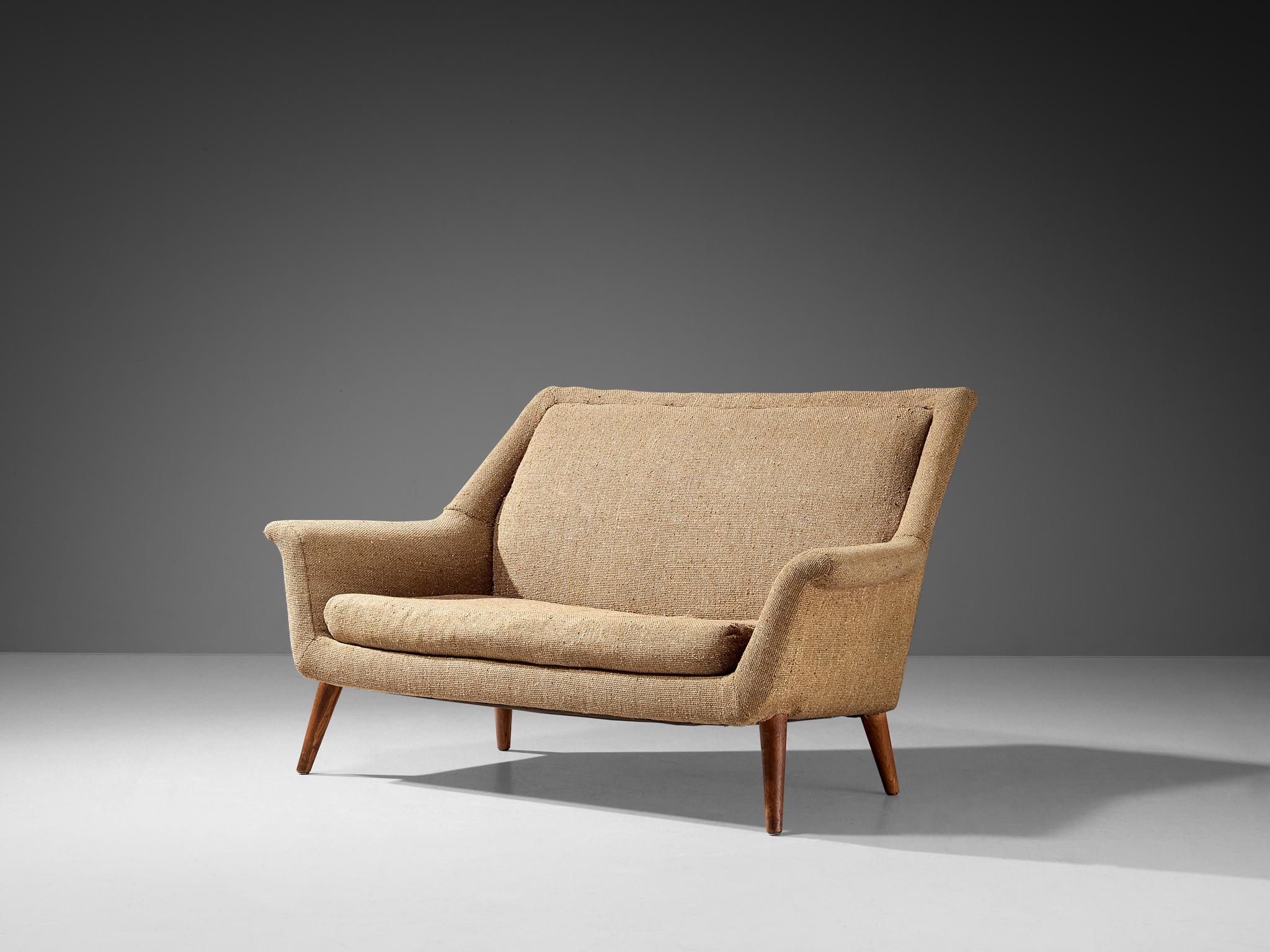 Sofa or settee, wool, teak, United Kingdom, 1960s.

This sofa has all the flair and vitality of a typical mid-century furniture piece. A nice detail is how the back smoothly runs over into the armrests, developing in a winged shape on both ends,