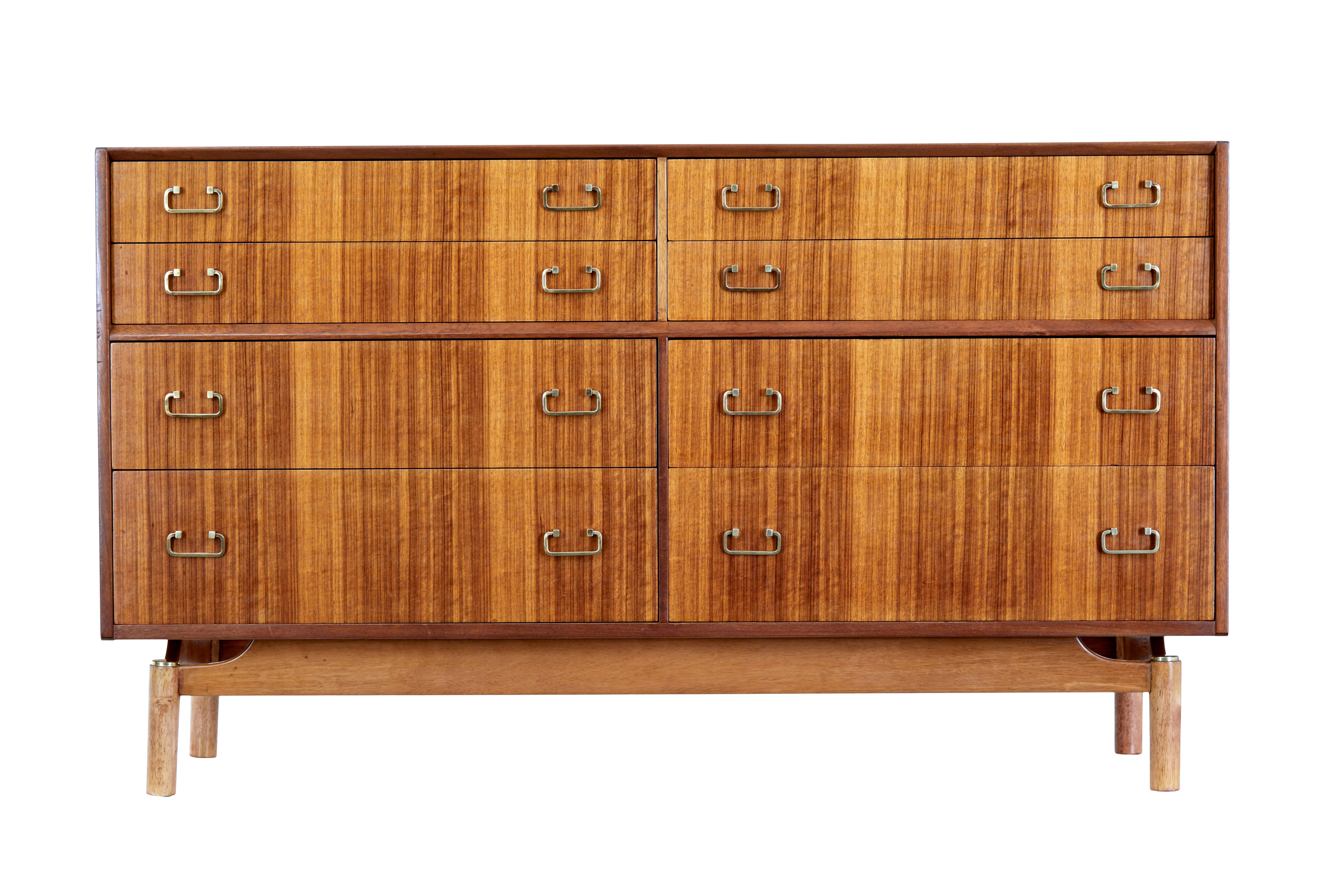 English midcentury teak sideboard circa late 1960s
Good quality and functional piece of furniture ready for everyday use.
Veneered in a striking teak grain. 1 piece, fitted with 4 drawers above a solid teak frame with a further 4 drawers below. This