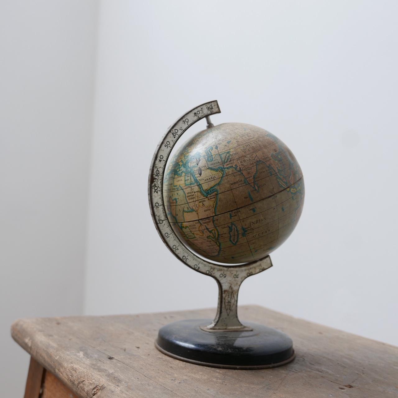 A small desk or shelf world globe curio. 

Tin or similar metal. 

England, c1960s. 

Dimensions: 21 Height x 15 Diameter in cm. 

Delivery: POA.

 