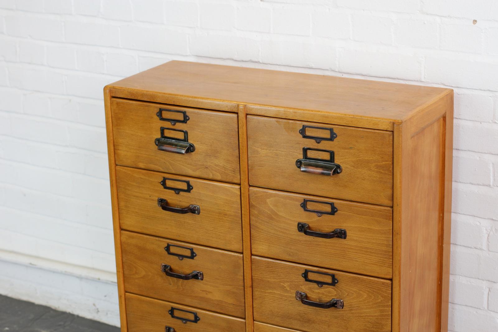 English midcentury beech school drawers, circa 1950s.

- Solid beech drawers and cabinet
- Original copper handles and card holders
- Dovetail jointed drawers
- English, circa 1950s.
- Measures: 78cm wide x 31cm deep x 89cm tall.
- Each