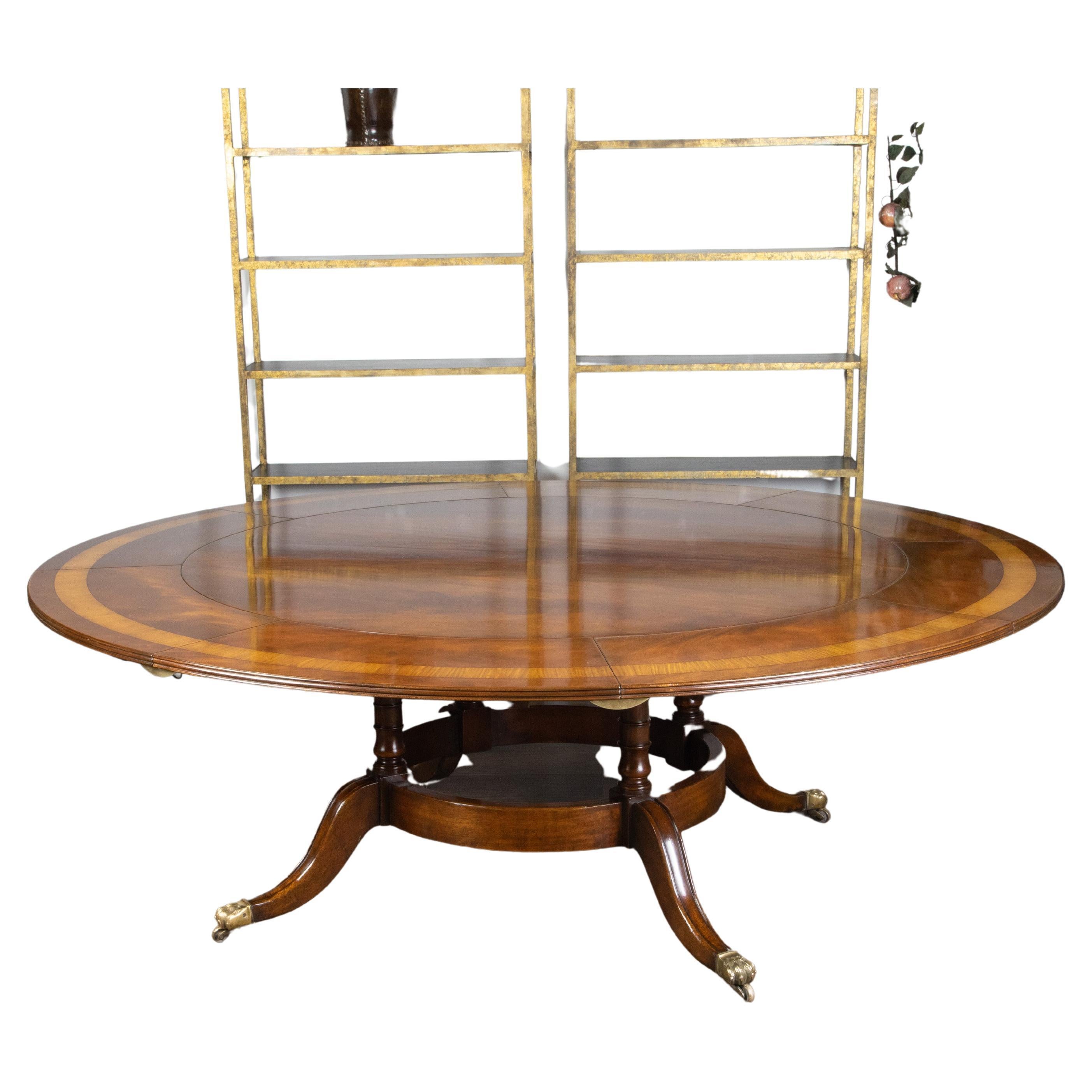 An English mahogany dining room table from the mid 20th century, with eight leaves and cross-banding. Created in England during the Midcentury period, this mahogany dining room table features a circular top measuring 60
