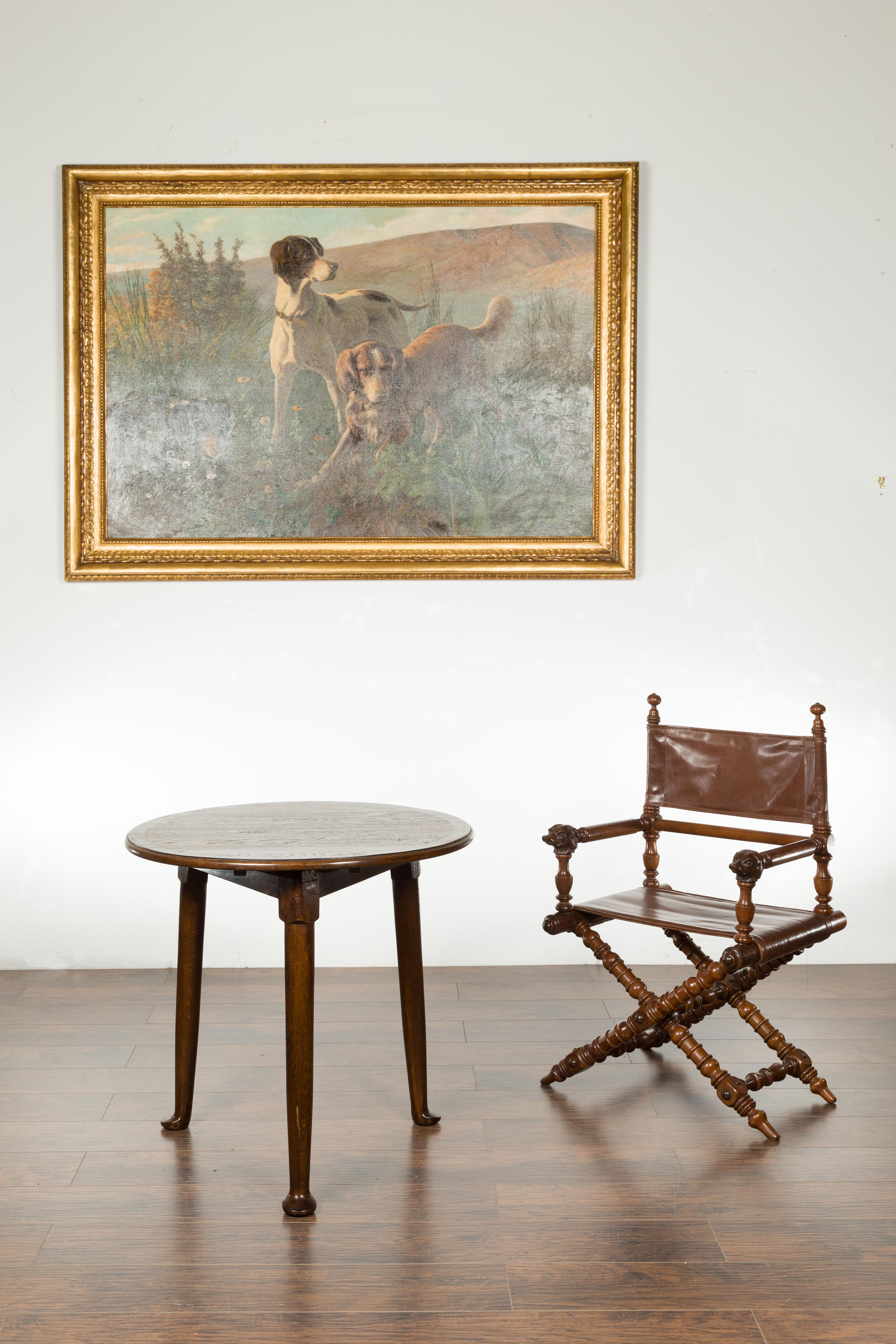 An English oak side table from the mid-20th century, with circular top and pad feet. We currently have two available, priced and sold $3,750 each. Created in England during the mid 20th century, this oak side table features a round top, framed on