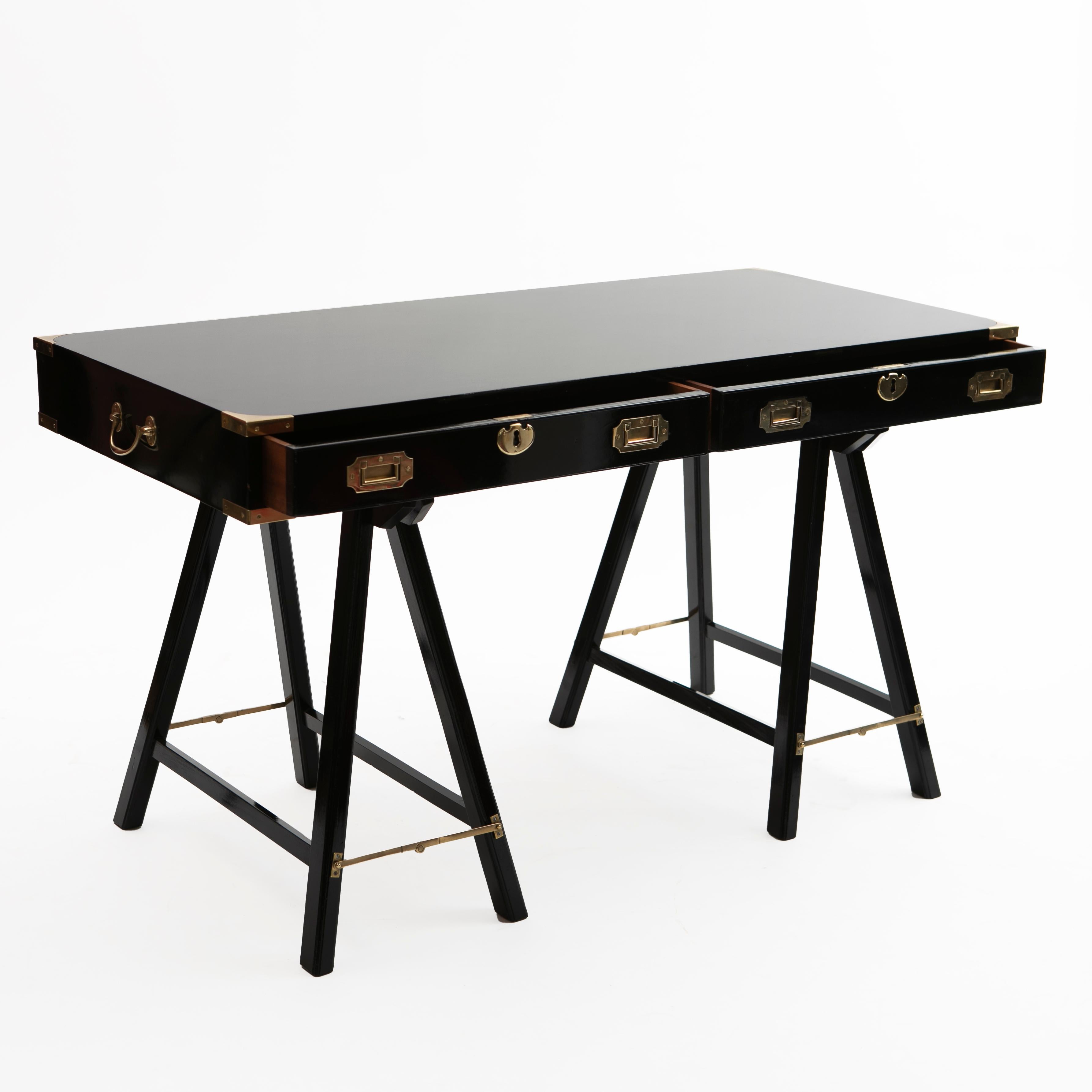 English military campaign trestle desk in black polished mahogany.
Front with two large size drawers with original brass handles and locks. The top separates from the base for easy transportation, fitted with carrying handles on both sides. Raised