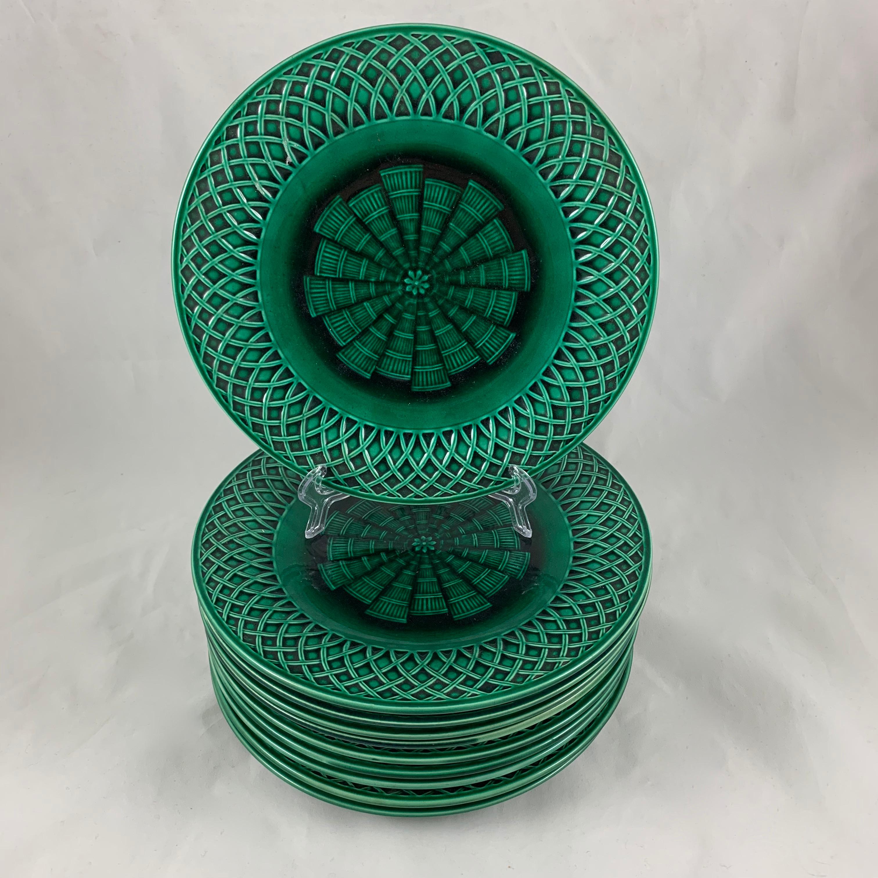 From Minton, Stoke-on-Trent, Staffordshire, England, a set of ten earthenware, majolica glazed plates.

The Aesthetic Movement plates have a latticework basketweave rim with a radiating, symmetrical woven fan pattern in the center – glazed in the