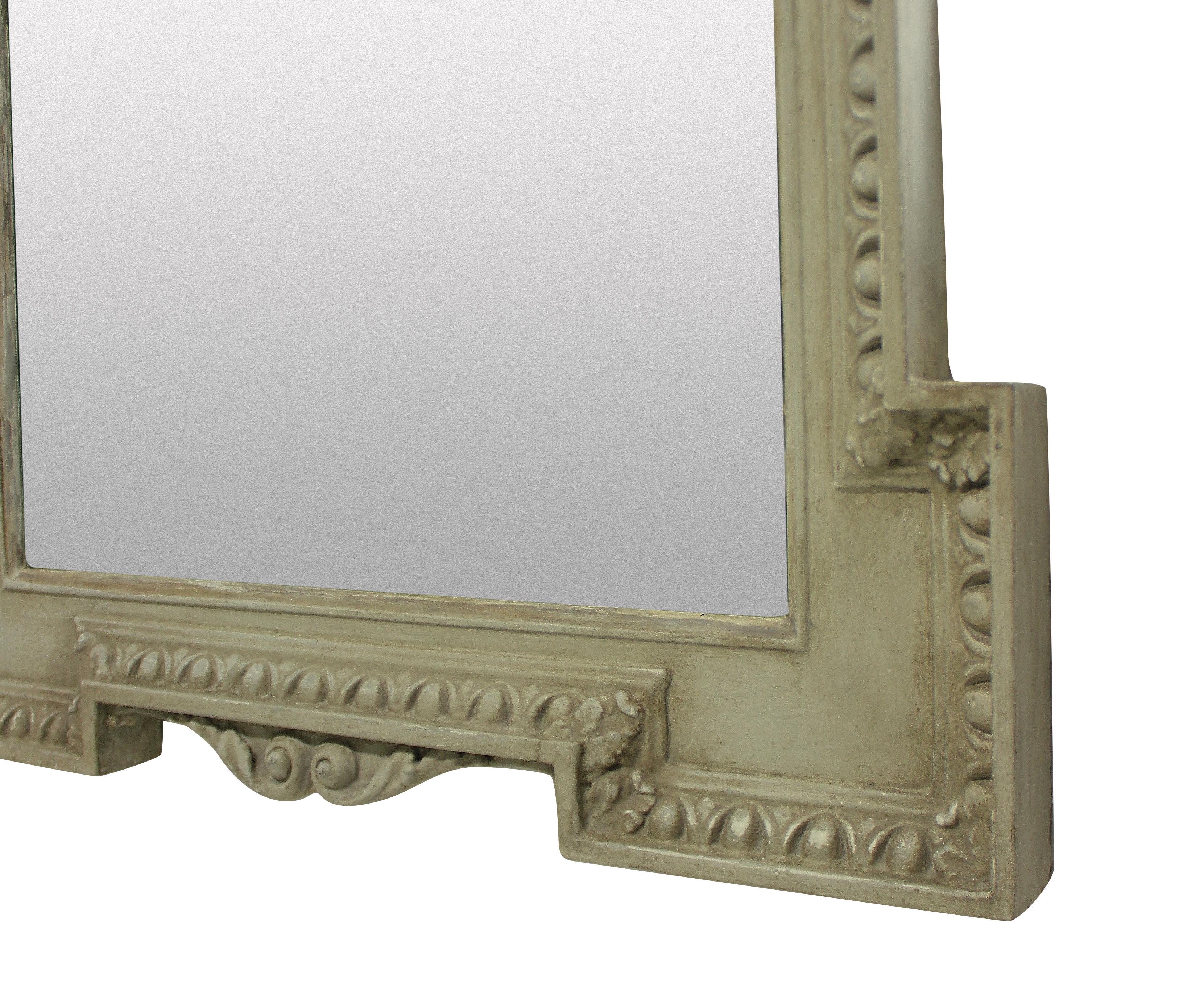 An English carved and painted mirror in the manner of William Kent, with a beveled mirror plate.