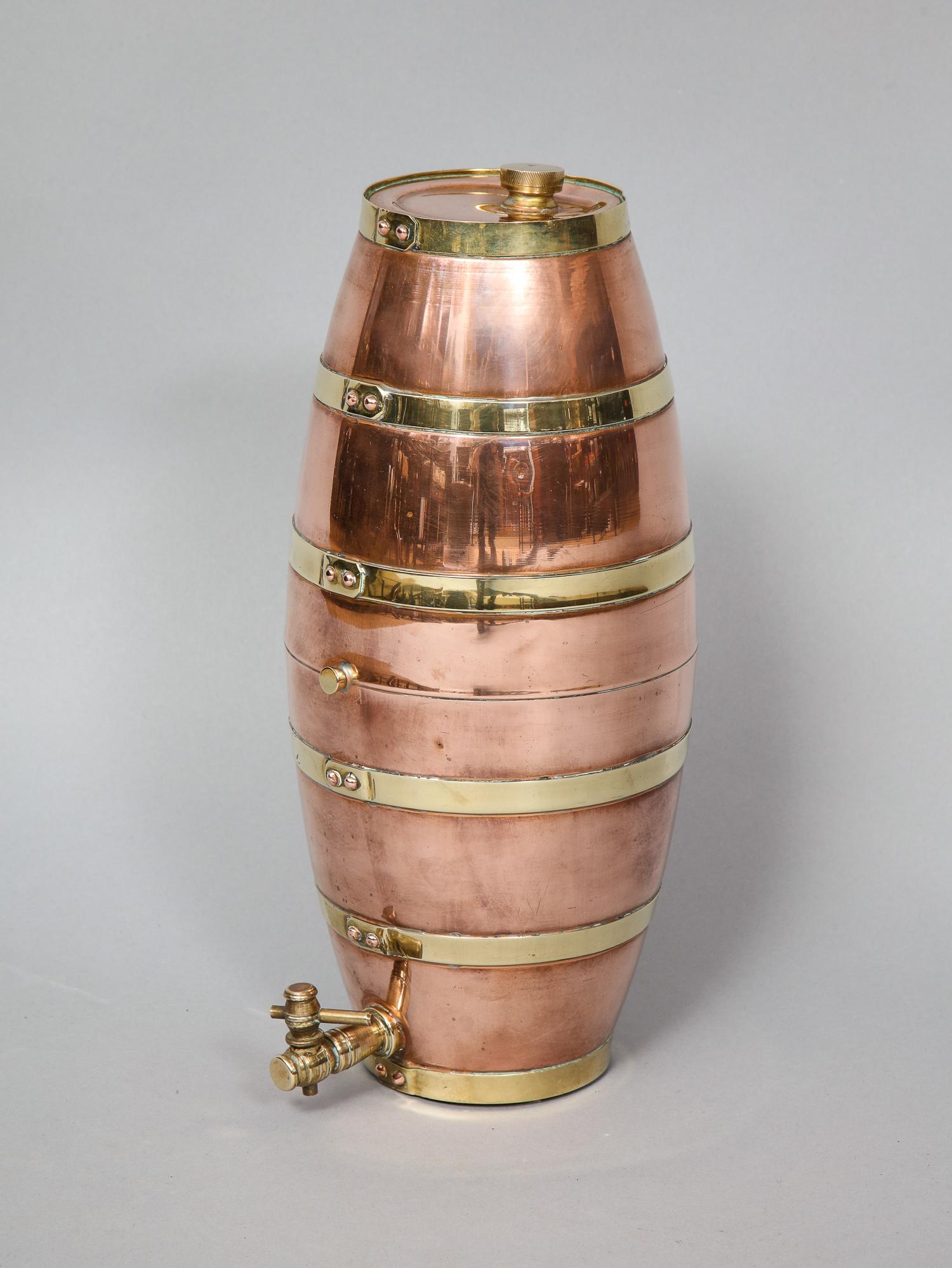 Fine Edwardian copper and brass spirit container of barrel form with riveted construction and having gleaming surface.