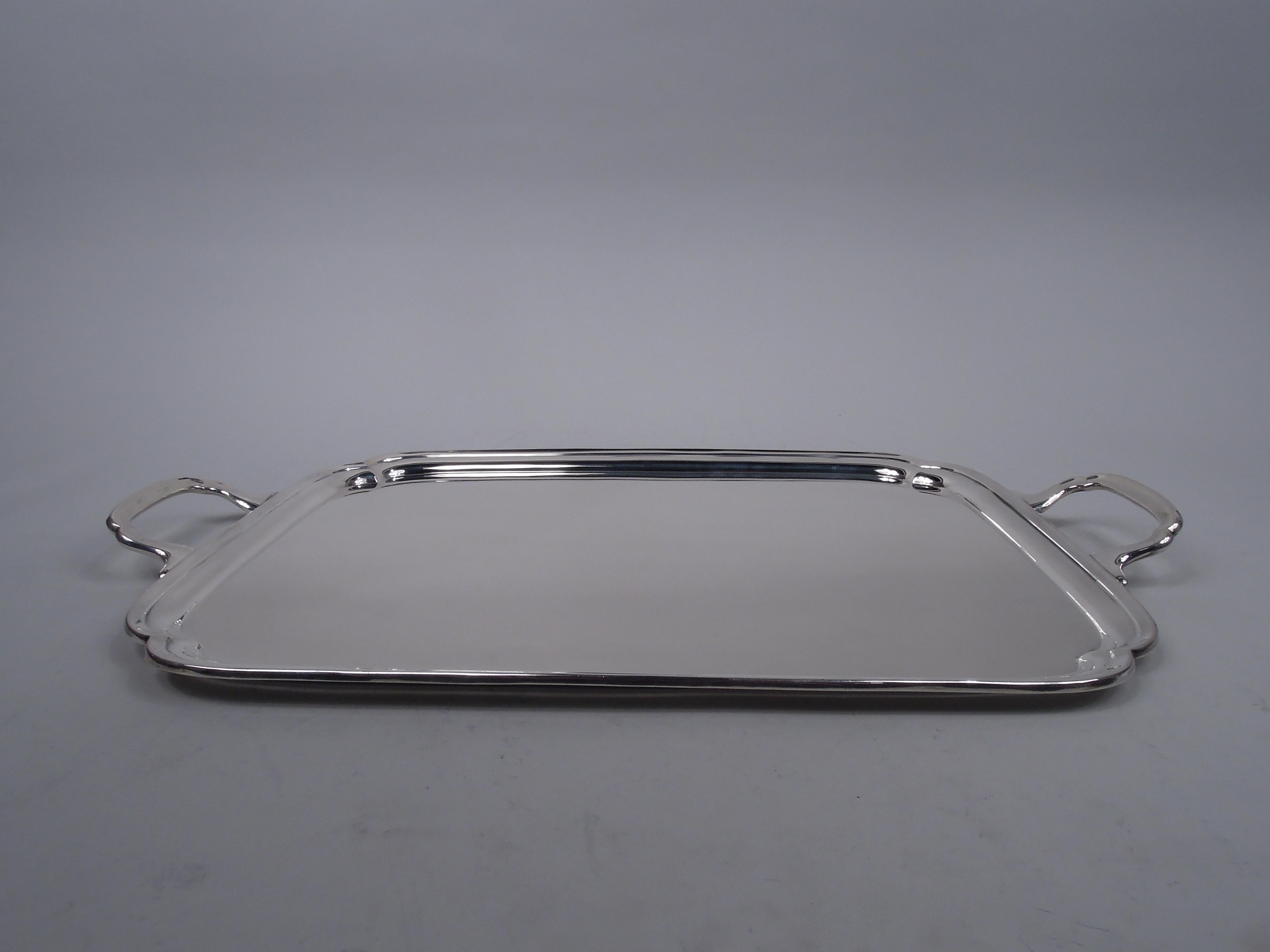 George VI sterling silver tray. Made by Edward Viner in Sheffield in 1950. Rectilinear with molded rim, double c-scroll corners, and bracket end handles. Fully marked including no. 0102/18 and stamp for Cheltenham & Co. (Sheffield), a division of