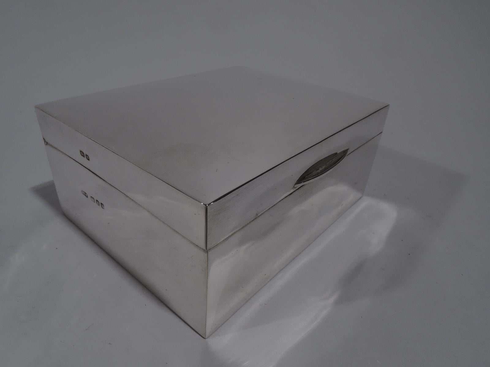 English Modern sterling silver desk box, 1958. Rectangular with straight sides. Cover hinged, tabbed, and gently curved. Box and cover interior cedar-lined and partitioned. Box underside leather lined. Fully marked including unidentified maker’s