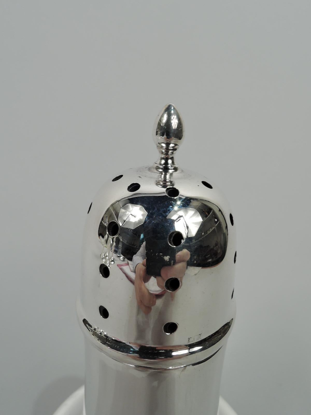 Elizabeth II sterling silver sugar caster. Made by J Collyer Ltd in Birmingham 1958. Upward tapering neck and curved bowl on short foot. Cover domed and pierced with ovoid finial. Plastic lining and cover threads. Fully marked. Gross weight: 4 troy