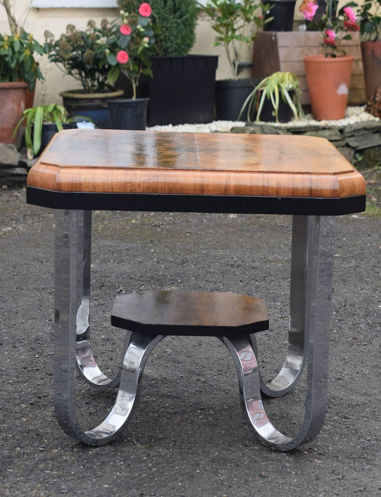A table with the wow factor is this totally authentic Art Deco modernist table dating to the 1930s. Features a very highly polished figured burl walnut top with an ebonised trim around the edge. The top is supported by four chrome U bend legs which