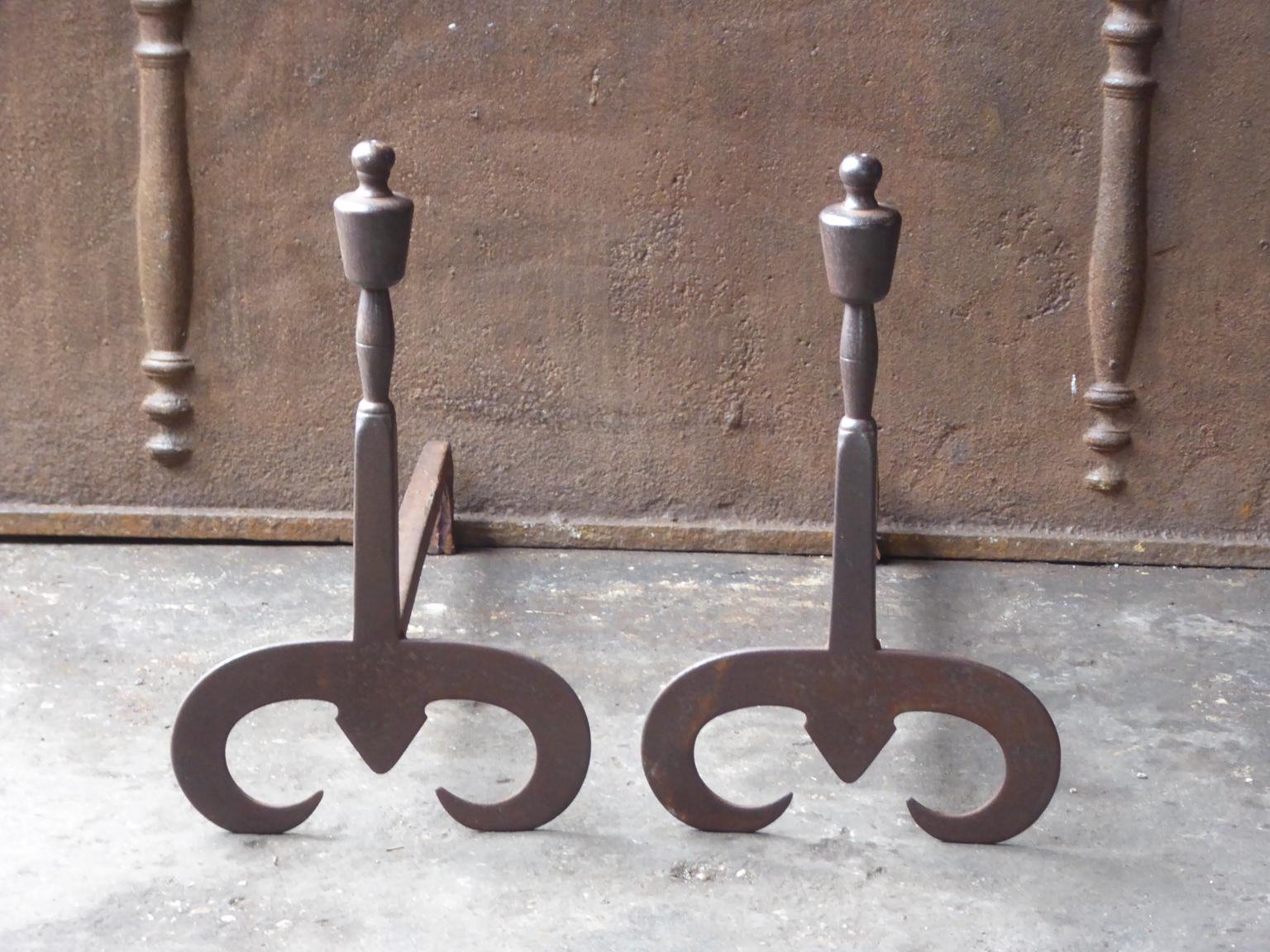 20th century English andirons made of wrought iron. The style is Modernist. The condition is good.


 