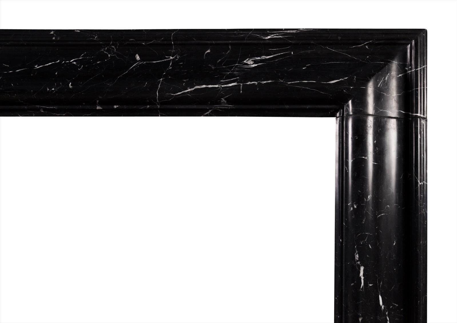 A stylish English molded bolection fireplace in Nero Marquina marble, originally from the Province of Bizcaya in Spain. A good quality copy of the Queen Anne design.

Shelf width:           1380 mm /   54 3/8 in
Overall height:      1205 mm /   47