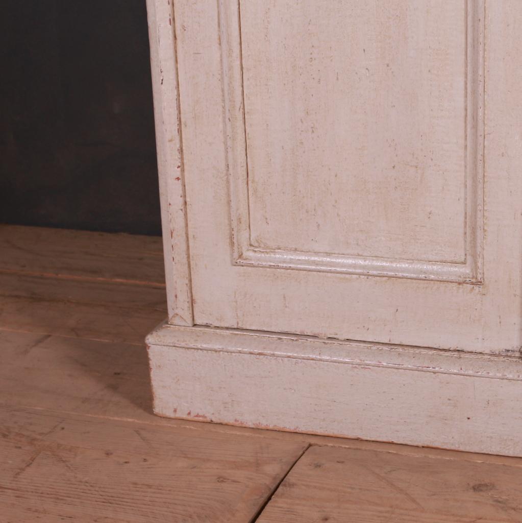 19th C narrow four door English painted pine side cupboard/ dresser base. 1850.

Dimensions
69 inches (175 cms) wide
13.5 inches (34 cms) deep
38 inches (97 cms) high.