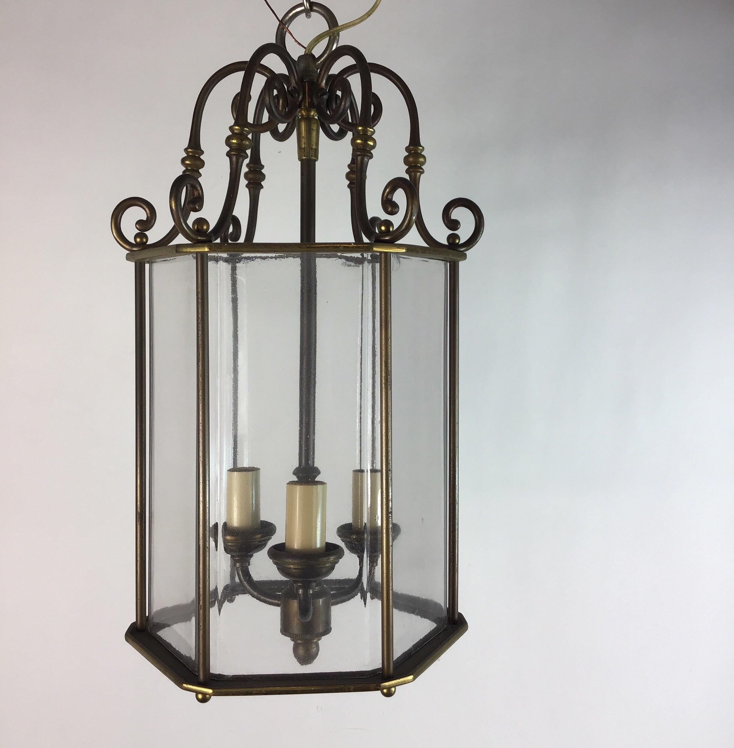 1-3056 English  patented brass hexagonal lantern with solid one piece glass shade. Three 40 W candelabra base bulbs. Newly rewired.