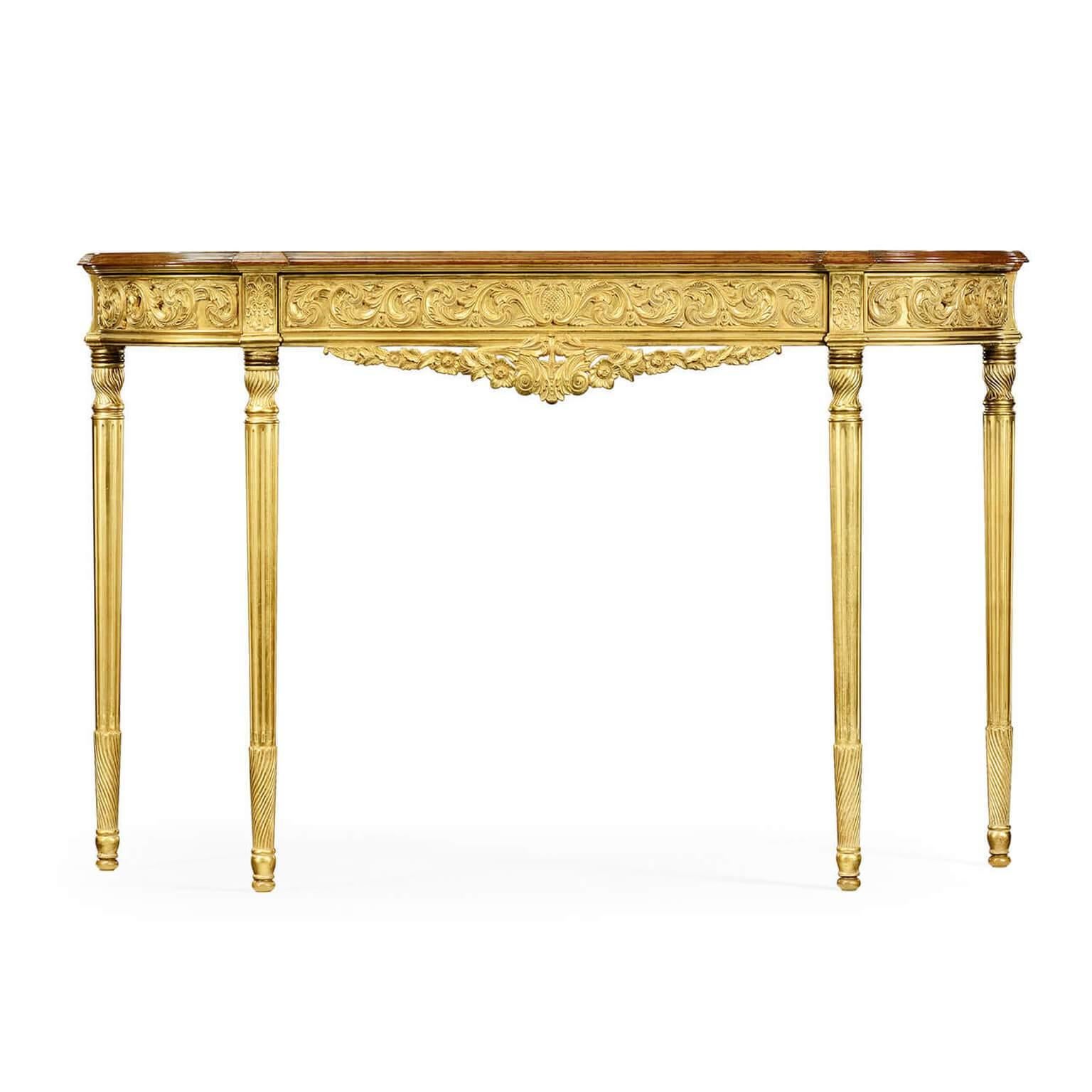 A fine George III neoclassic D form console table with a marquetry inlaid satinwood top, an elaborately carved giltwood frieze of scrolling leaves above finely turned and carved fluted legs.

Dimensions: 57 3/4