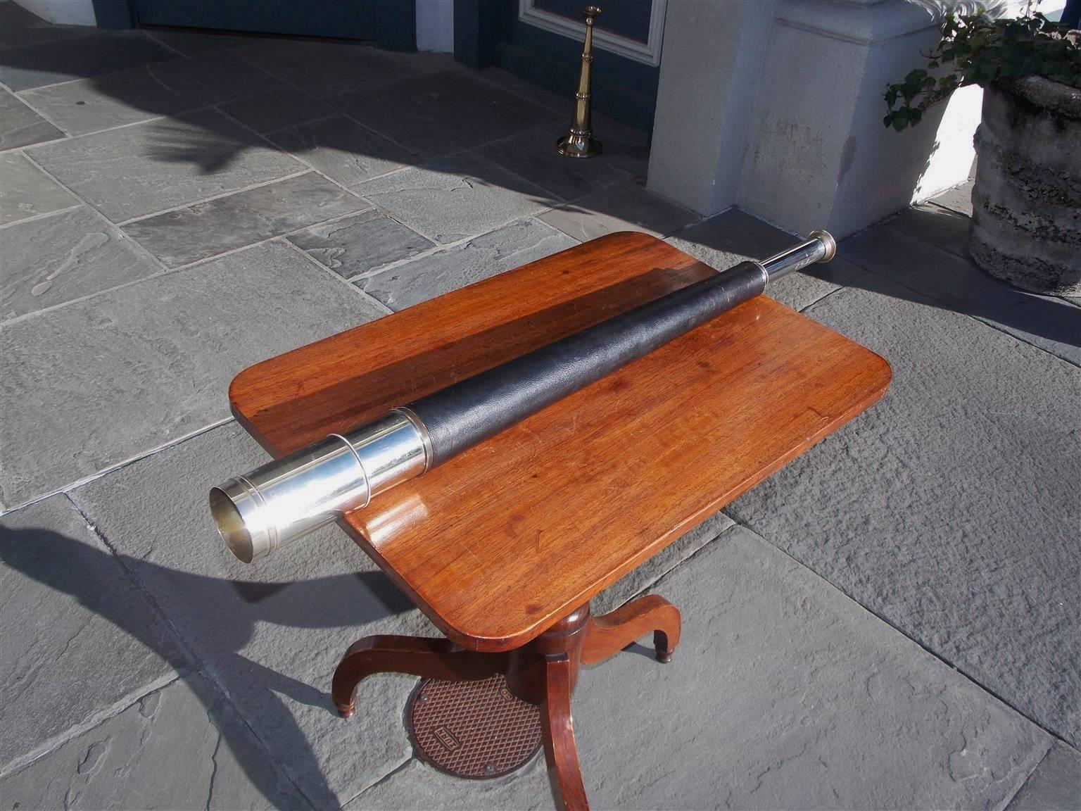 English nickel silver over brass nautical ship captain's spyglass with a covered leather barrel, single draw, polished sunshade, and engraved focal tube by maker Andrew Ross of London, Mid-19th Century. Spyglass is in working condition with crystal