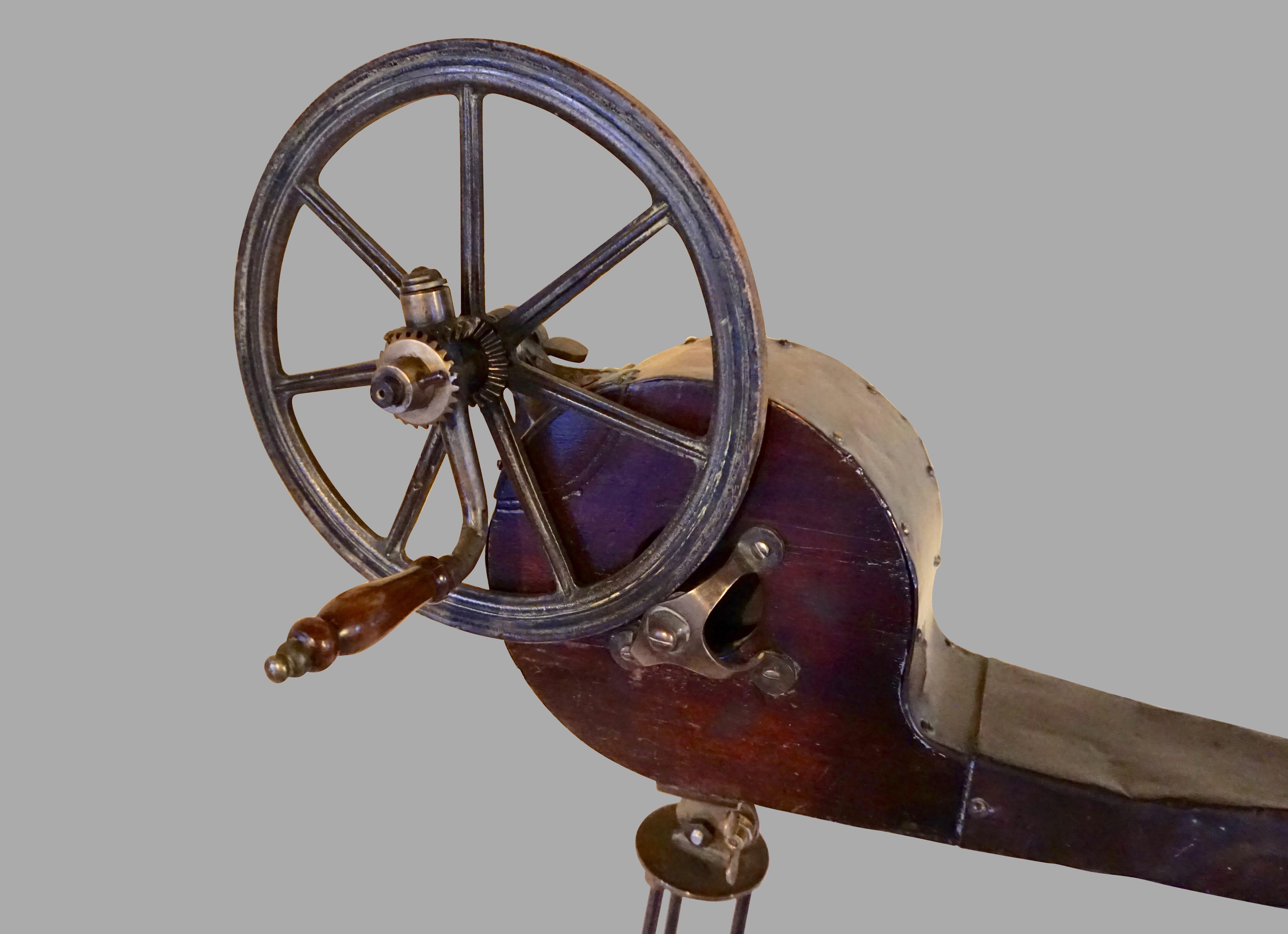 An interesting early 19th century mechanical bellows made of mahogany and brass resting on a bronze or brass stand. This unusual piece has a wonderful sculptural quality and is adjustable as to the angle of the nozzle. 
Show signs of loving