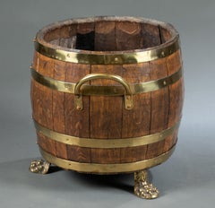 English Oak and Brass Barrel Shaped Cellarette with Paw Feet