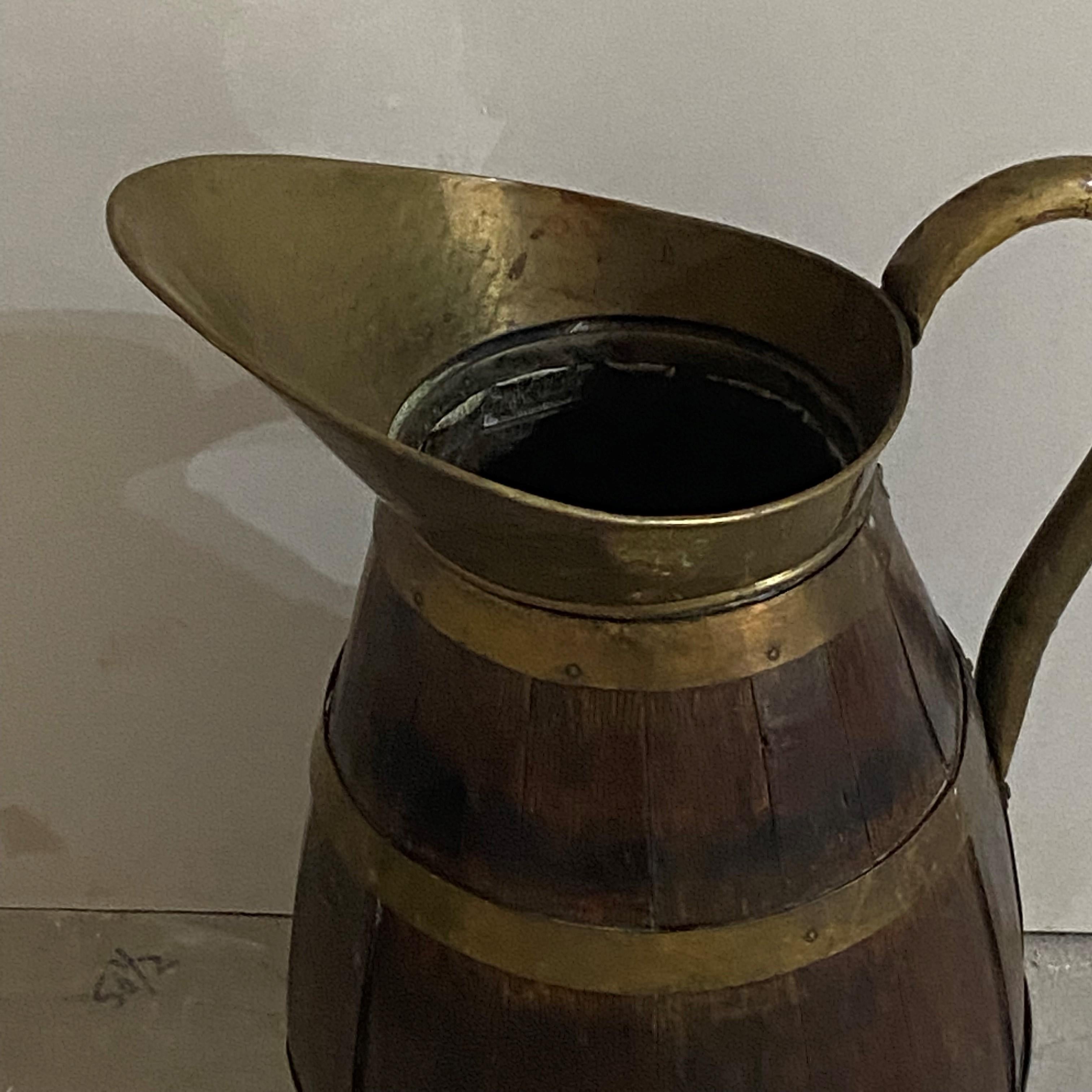 Great Oak pitcher with brass handle and mount.  Haviong brass bands and this was made by a skilled cooper.