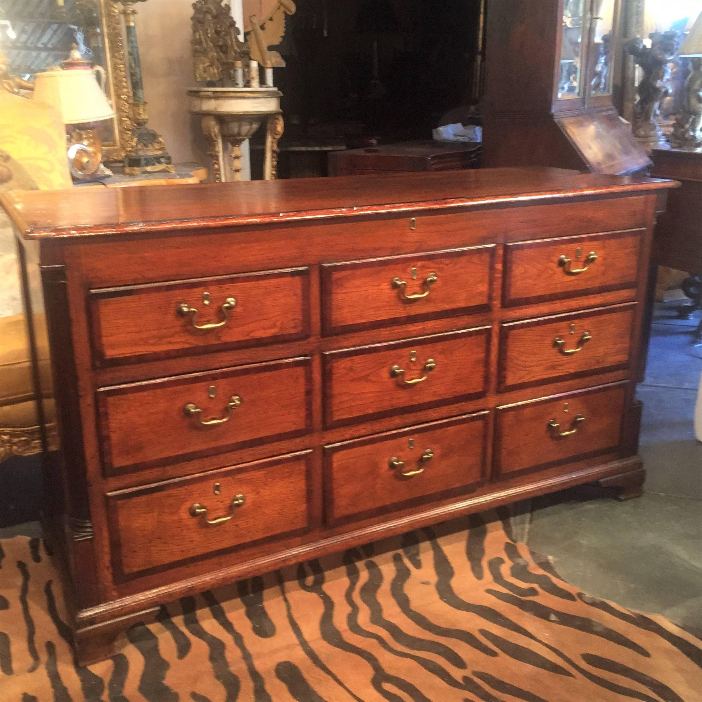 With nine mahogany banded working drawers. Originally with a lift top opening to a storage well. The top row ( or two ) of drawers most likely faux and later (circa 1900 ) converted to working drawers , The top now secured down. The whole casing