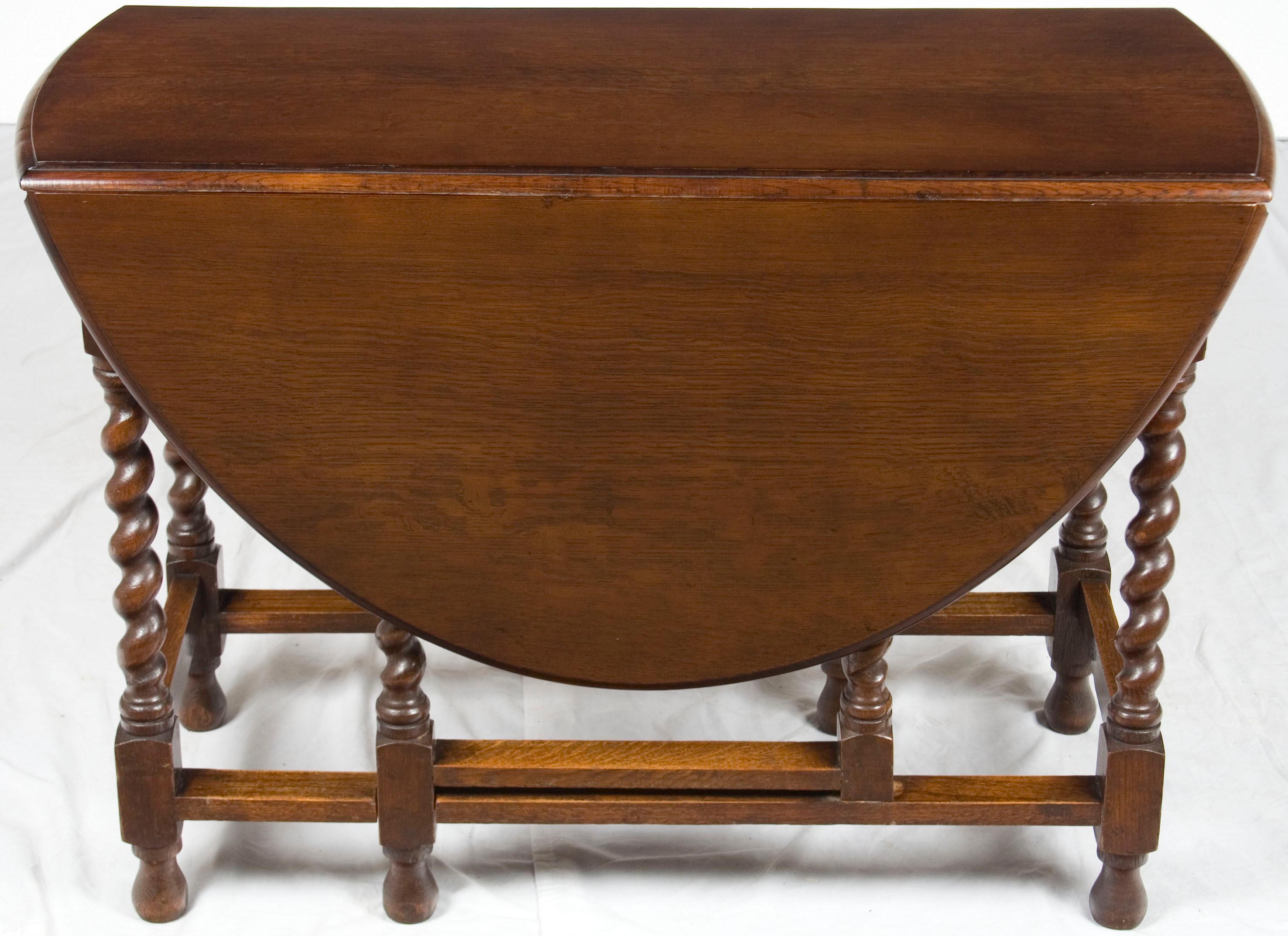 A fine example of English craftsmanship, this lovely gate leg table was handcrafted, circa 1920. Today it is a very beautiful and charming piece, perfect for use in the home or office as a side or dining table.

English cabinetmakers first began